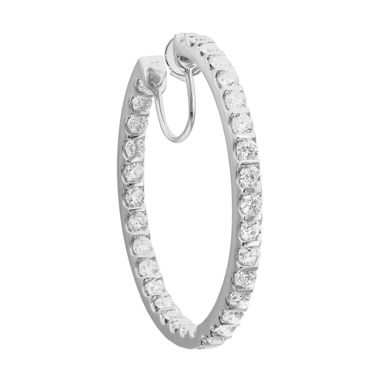 Enhance your ensemble with the exquisite allure of these radiant diamond inside-out hoop earrings. Meticulously fashioned in opulent 18K white gold, each earring emanates brilliance from every perspective, adorned with a dazzling array of round