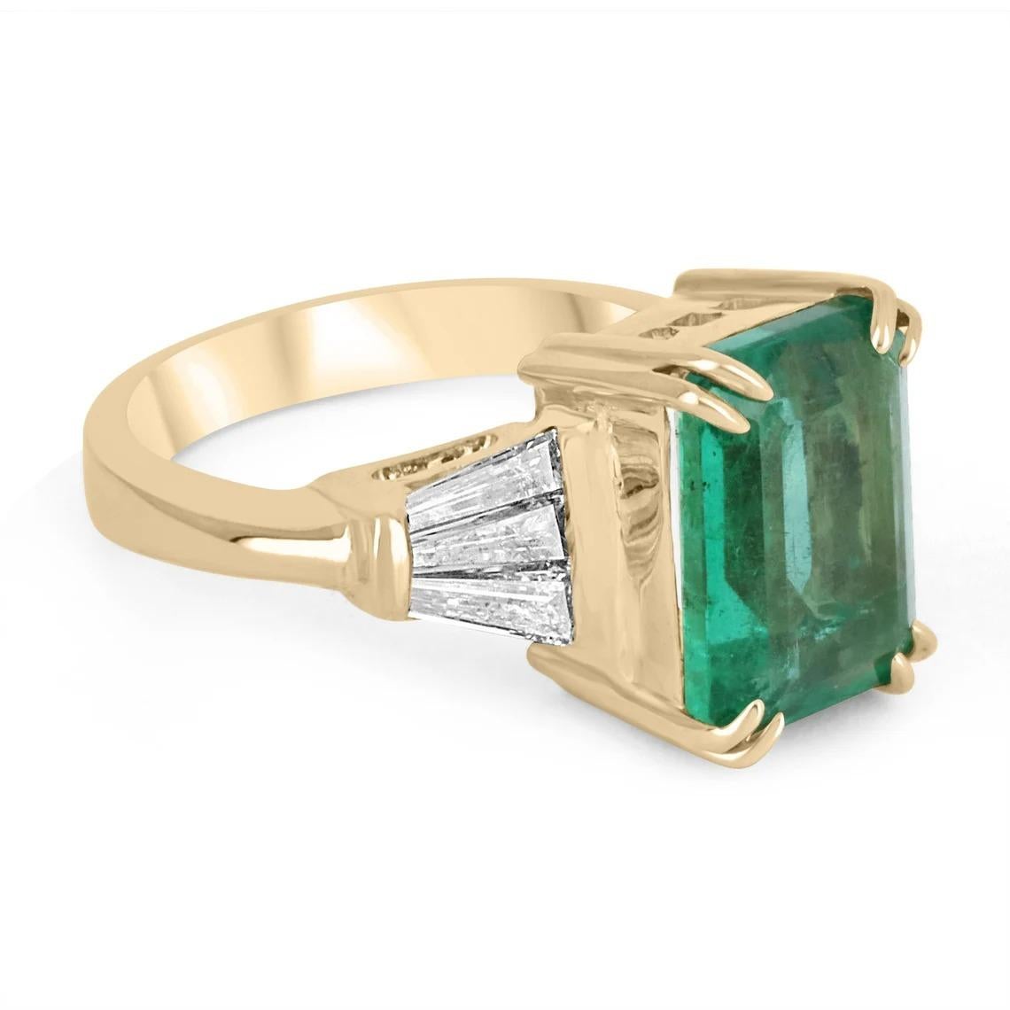 Featured is a magnificent, natural emerald and diamond ring. In the very center is a gorgeous, 3.86-carat emerald-emerald cut; displaying a stunning, medium-dark green color, and excellent luster. Accented on the sides, are six tapered baguette