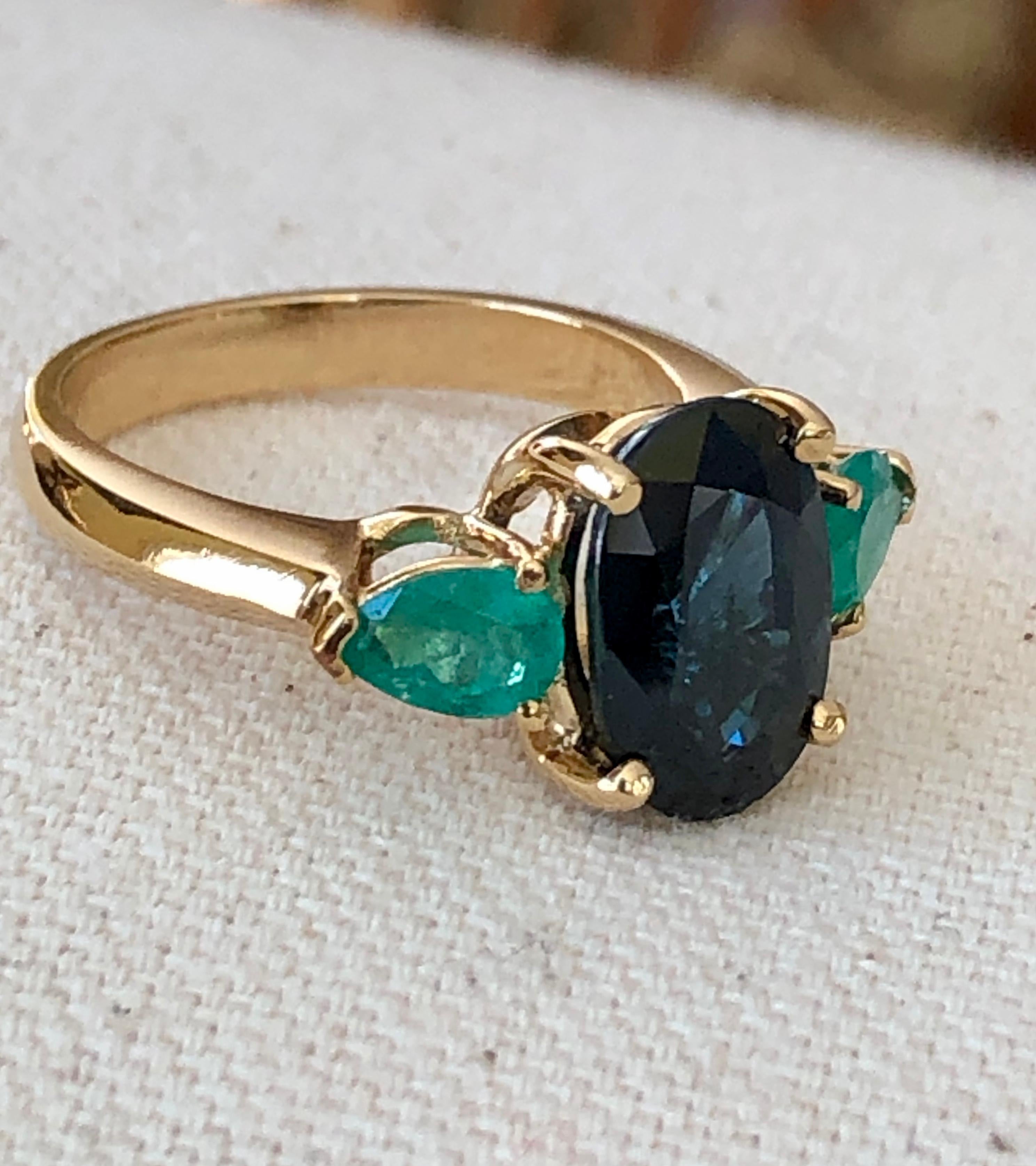 This Unique Natural Blue Sapphire and Colombian Emerald Engagement Cocktail Three Stone Ring is made of Rich Yellow Gold  18 Karat.
Featuring a stunning 4.07 Carat Natural Sapphire Cobalt Blue, Oval Cut, VS.
Sapphire Measurements: 11.50mm x 8.00
