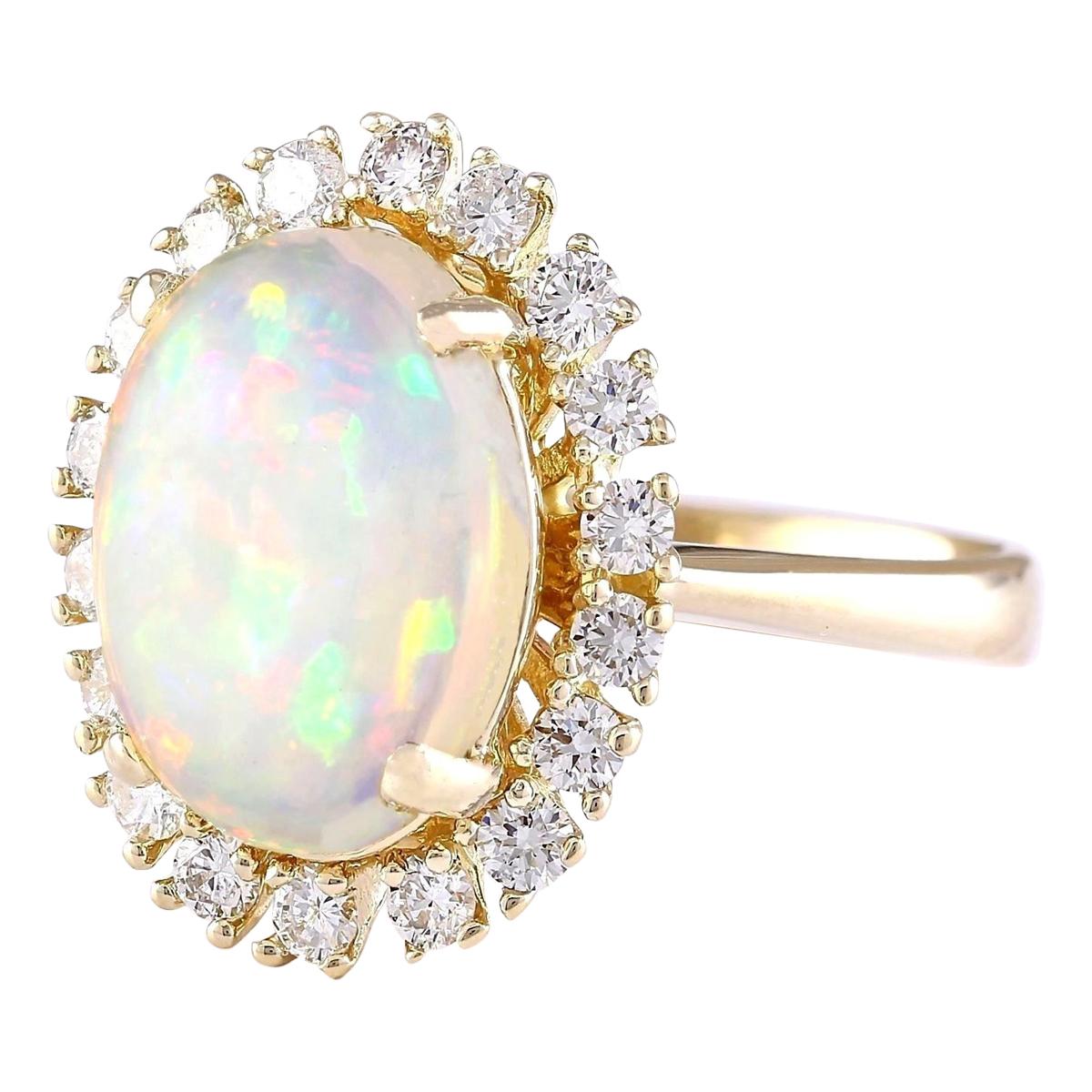 4.77 Carat Natural Opal 14 Karat Yellow Gold Diamond Ring
Stamped: 14K Yellow Gold
Total Ring Weight: 8.8 Grams
Total Natural Opal Weight is 3.97 Carat (Measures: 14.00x10.00 mm)
Color: Multicolor
Total Natural Diamond Weight is 0.80 Carat
Color: