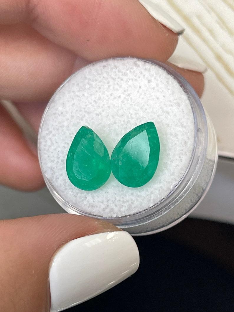 Stone: Emerald
Total Weight: 4.77-tcw
Shape: Pear Cut
Clarity: Semi-Transparent
Luster: Good
Color: Medium Green
Measurements: 11.06mm x 7.87mm x 5.43mm // 10.68mm x 7.75mm x 5.21mm
Geographic Origin: Colombia
Treatment: Natural, Moderate Oil with