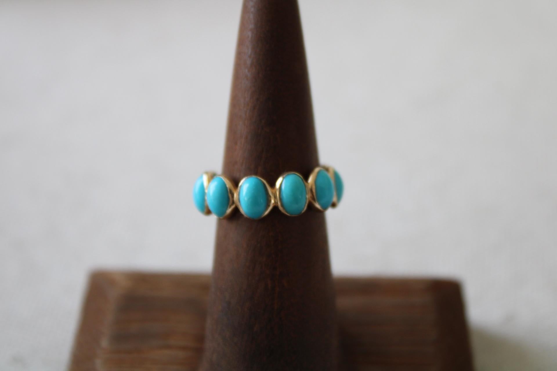 This 14K Gold Turquoise eternity band has 12 cabochon turquoise stones totaling 4.78 carat weight. The ring is size 7 and is bezel set in 14K gold. The turquoise stones are  ethically sourced in Jaipur and made in the USA.
This ring is smooth on the