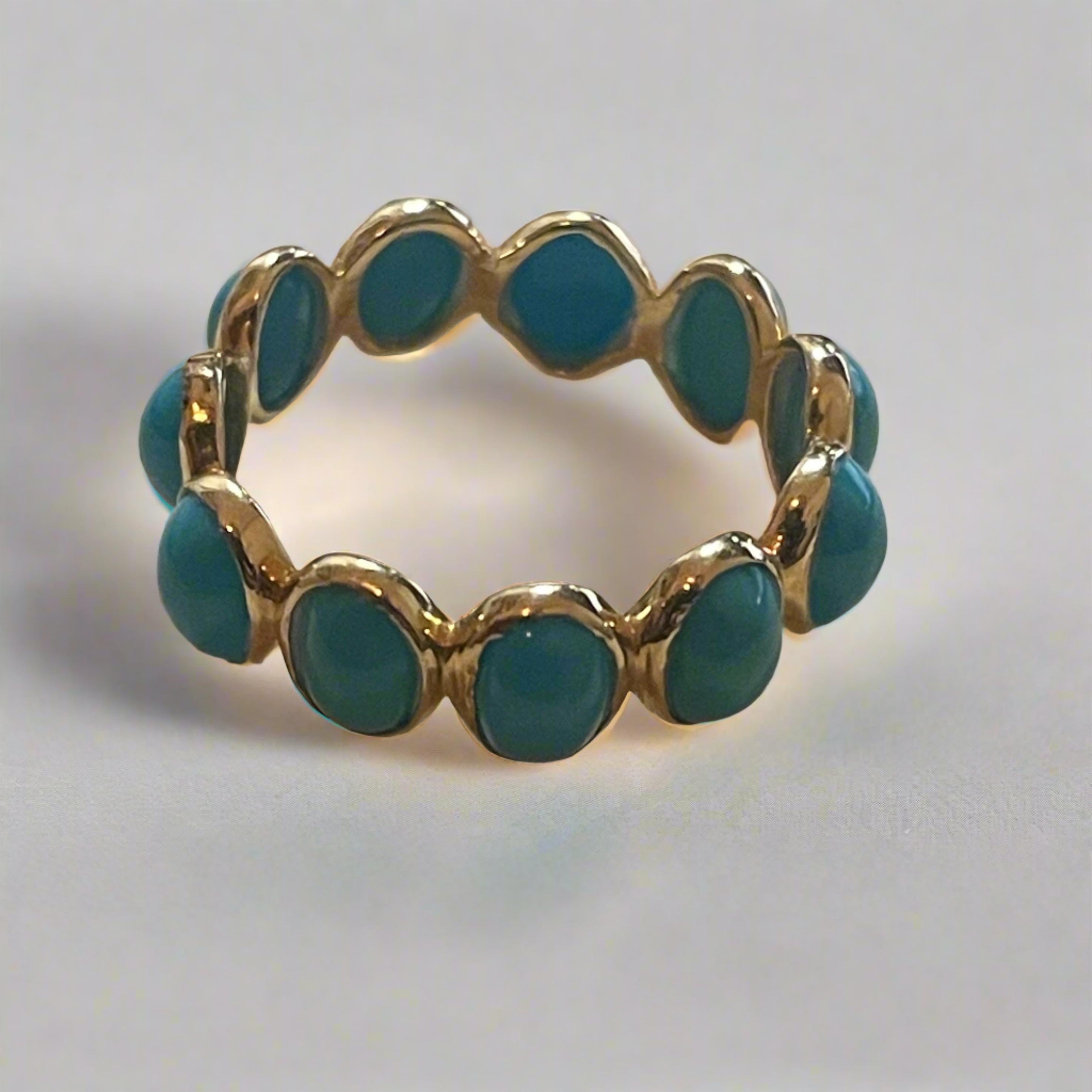 This 14K Gold Turquoise eternity band has 12 cabochon turquoise stones totaling 4.78 carat weight. The ring is size 7 and is bezel set in 14K gold. The turquoise stones are  ethically sourced in Jaipur and made in the USA.
This ring is smooth on the