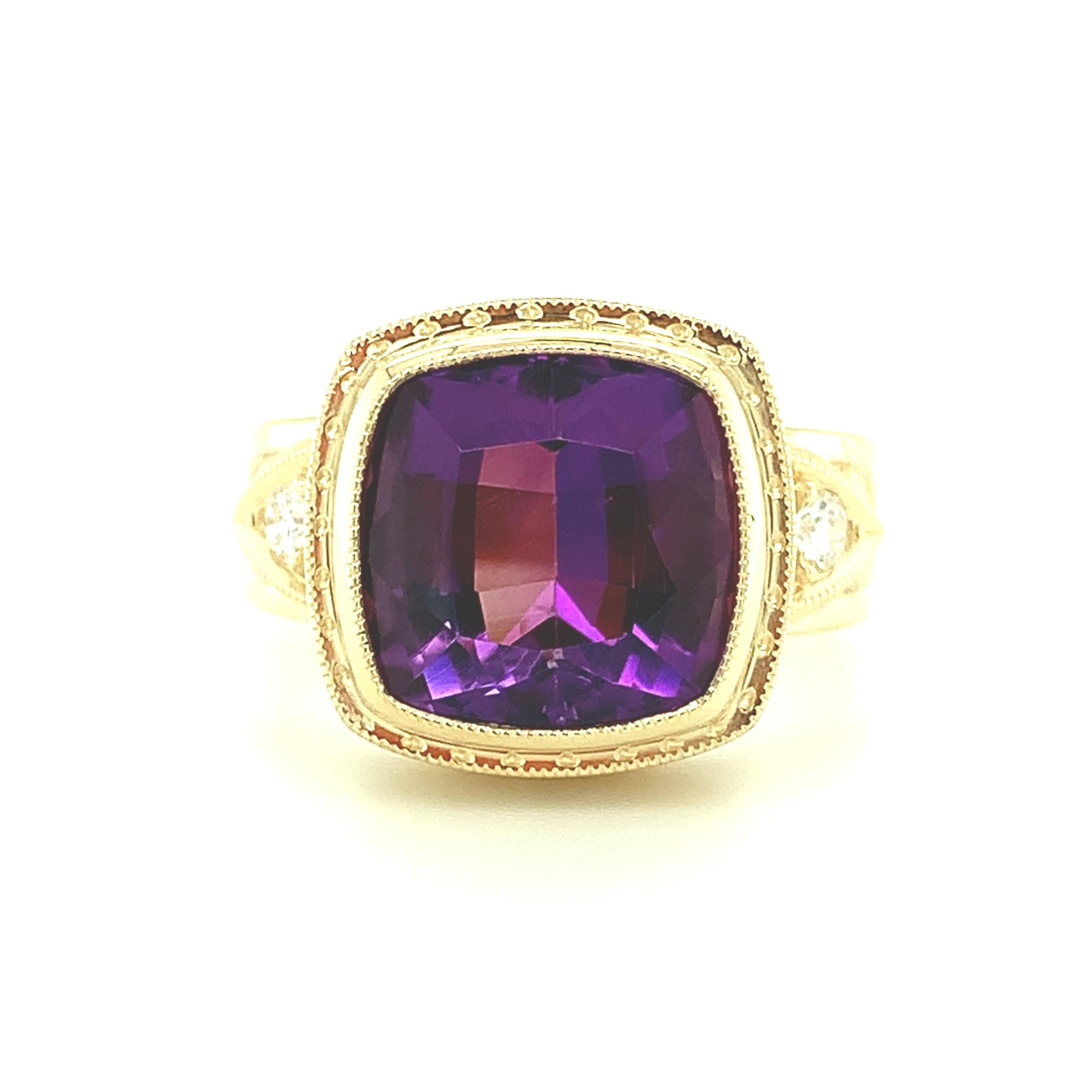 This beautiful ring features a lovely lavender color amethyst that has been set in a handmade 18k yellow gold bezel. The cushion-shaped gemstone has beautifully rich color and is accented by two sparkling, round brilliant white diamonds. The sides