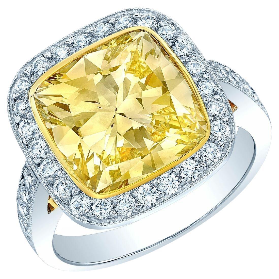 Platinum and 18 Karat Yellow Gold Engagement Ring with 1 Fancy Very Light Yellow Cushion Cut Diamond and Round Brilliant Diamonds: This ring incorporates both platinum and 18 karat yellow gold in its design. It features a fancy very light yellow