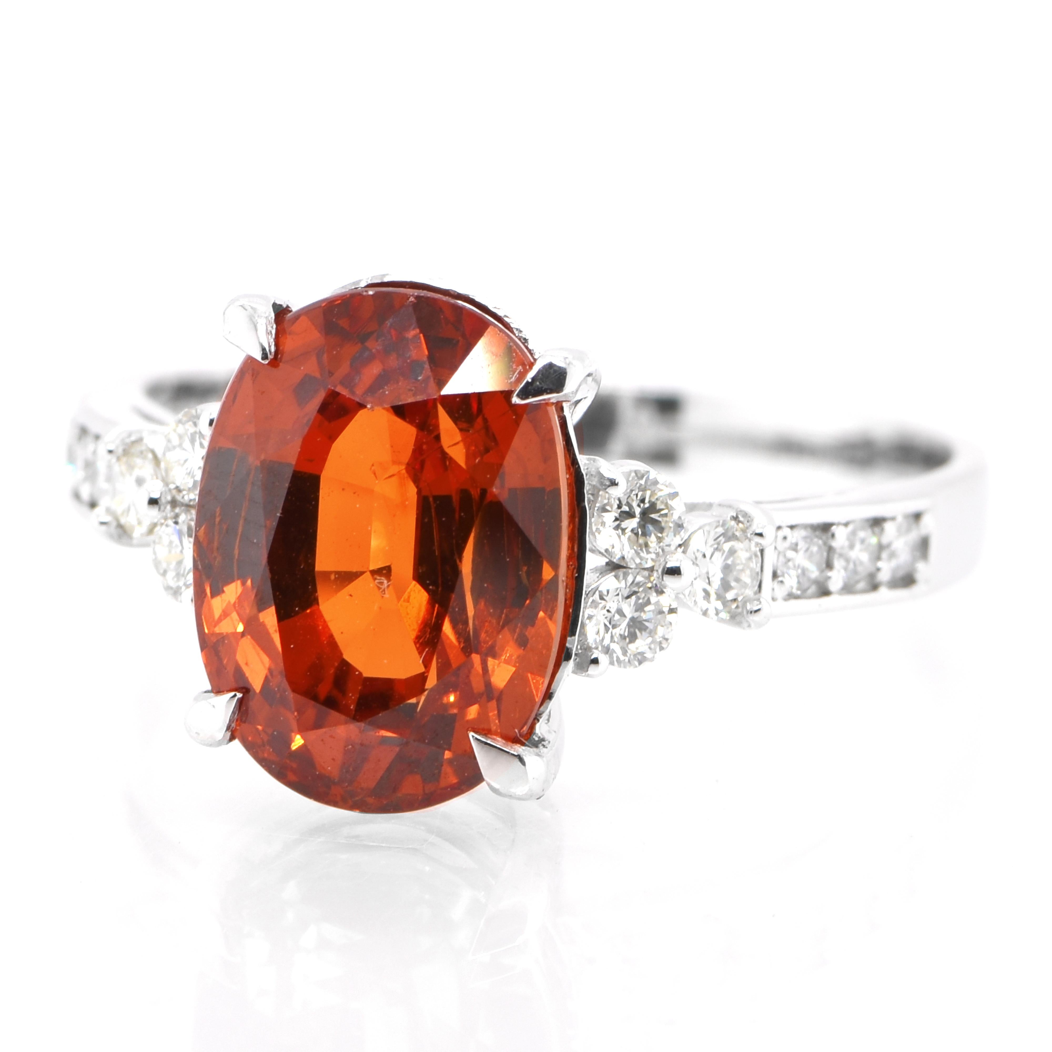 An absolutely gorgeous Cocktail Ring featuring a 4.78 Carat, Natural Spessartine Garnet and 0.25 Carats of Diamond Accents set in Platinum. Garnets have been adorned by humans throughout history from Ancient Egypt, Rome and Greece. They come in a