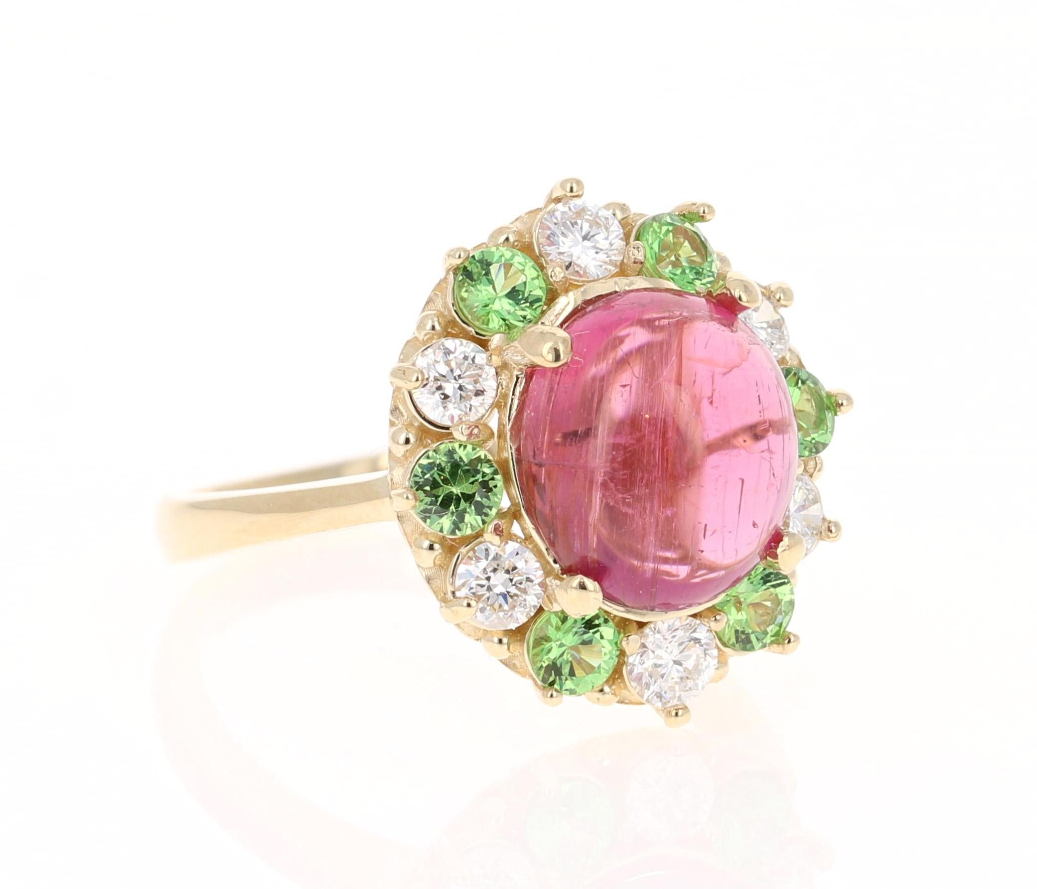 Stunning and uniquely designed 4.78 Carat Pink Tourmaline, Tsavorite, Diamond Yellow Gold Cocktail Ring! 

This ring has a 3.66 Carat Oval Cabochon Cut Pink Tourmaline that measures at 10 mm x 11 mm (width x length) and is surrounded by 6 Tsavorites