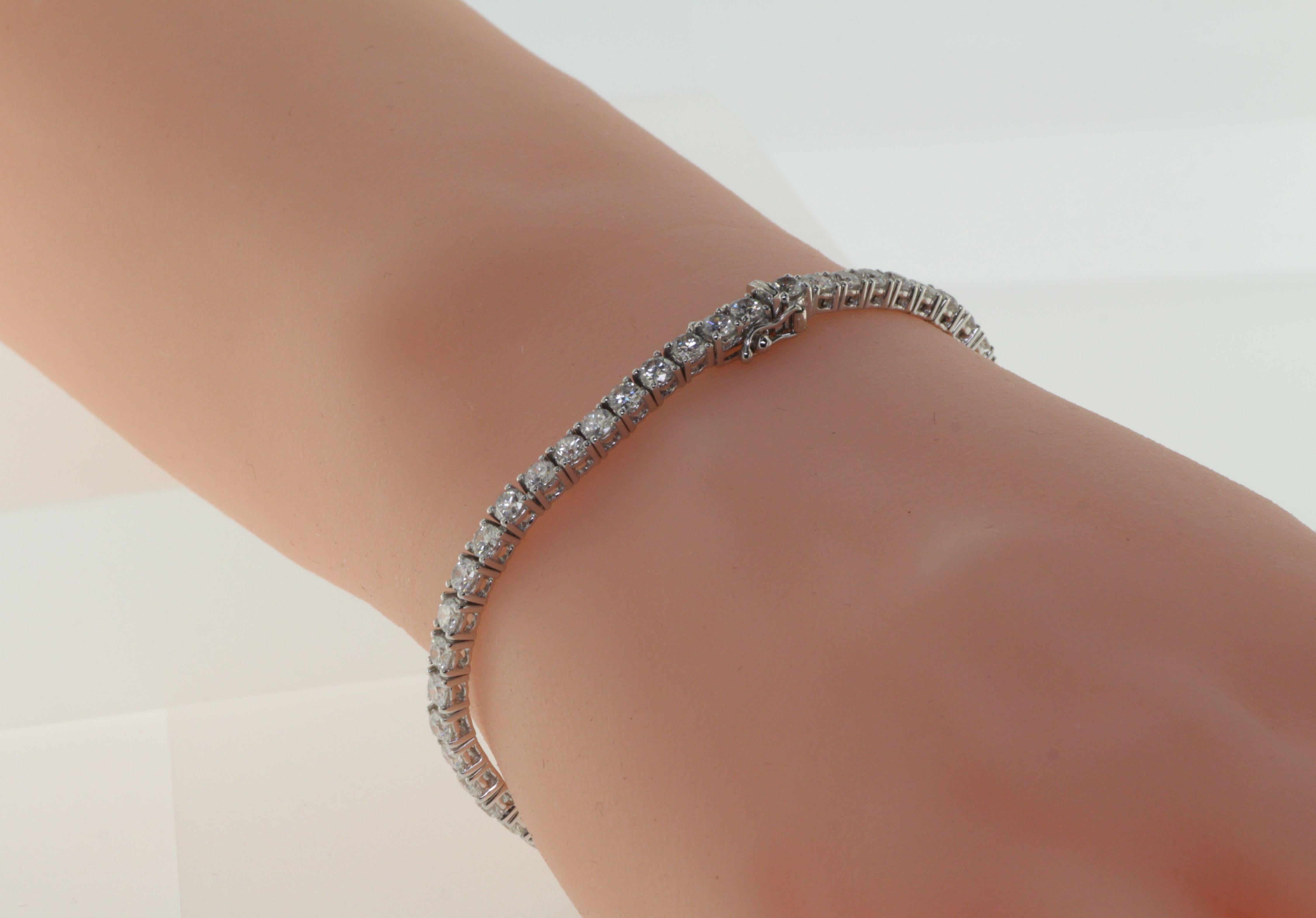 This stunning tennis bracelet is set with 4.78 carats of gorgeous, sparkling diamonds! Set in all 18 karat white gold, each of the diamonds has been hand-selected and matched for size and quality. Each stone is extremely well-cut for maximum