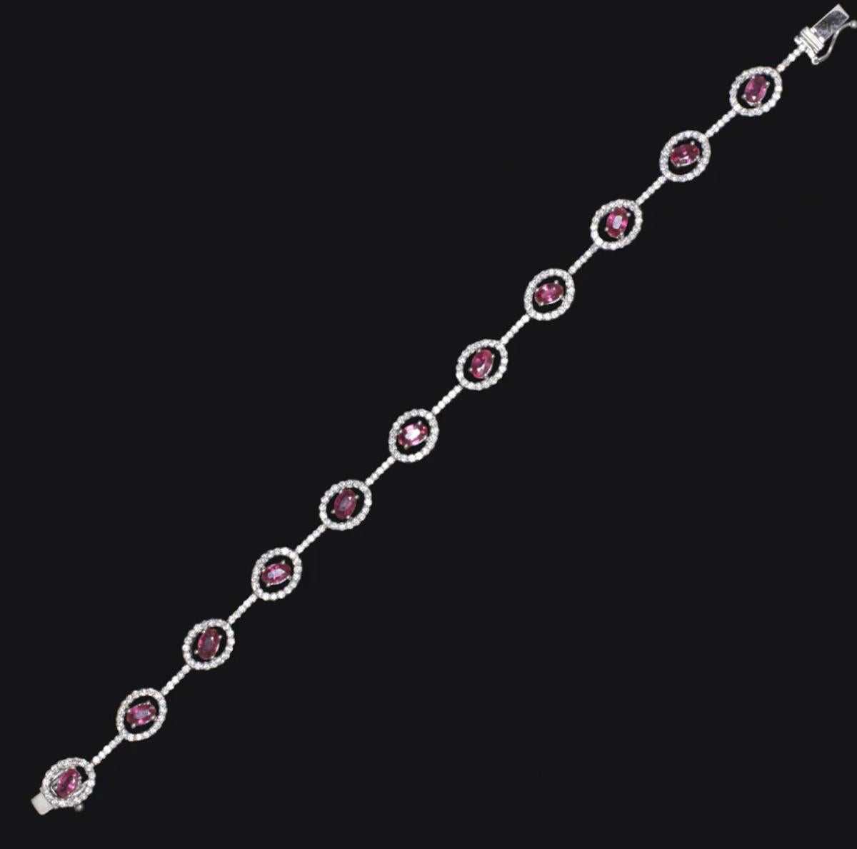 Crafted in luxurious 18K white gold, this vibrant bracelet features a bold yet refined design with richly saturated rubies and brilliant diamonds. The piece showcases approximately 3.00 carats of natural oval-cut rubies in a unique angled layout,