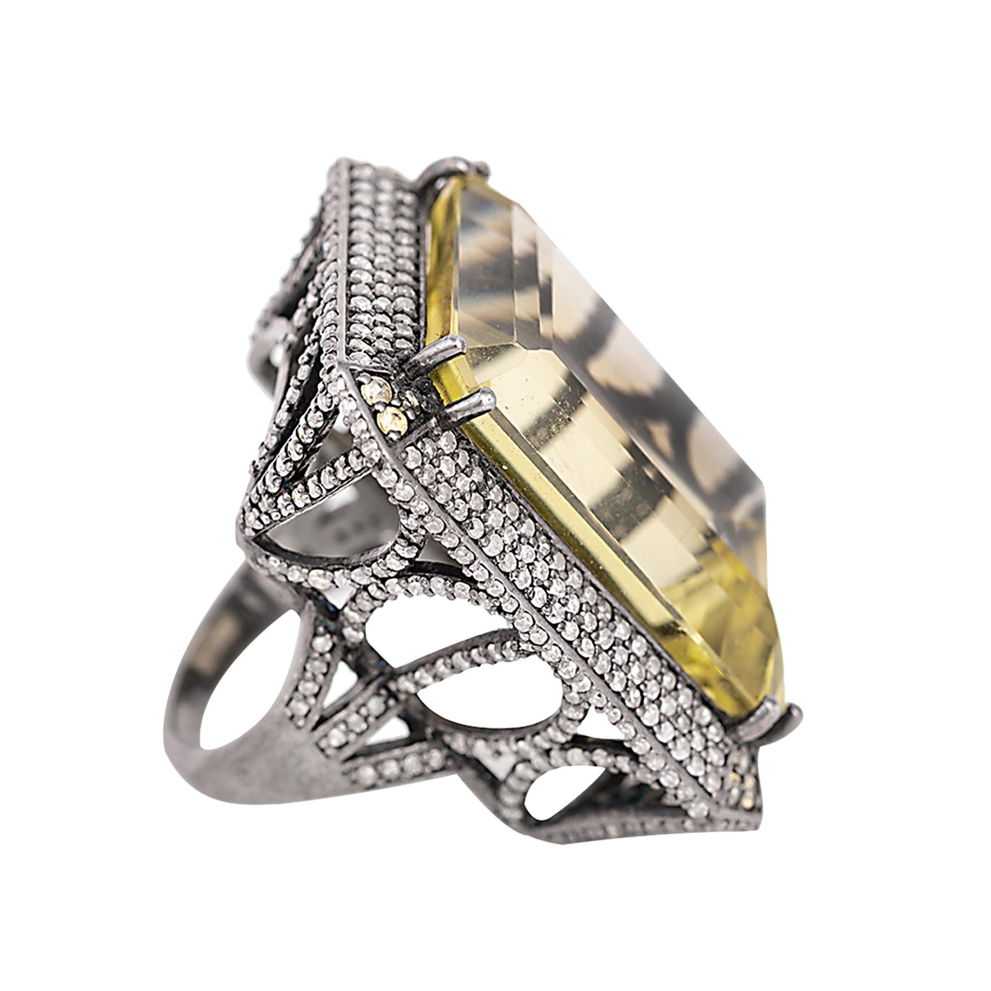 47.81 Carat Lemon Topaz and Diamond Cluster Cocktail Ring in Victorian Style

This Victorian era art-deco style incredulous lemon topaz and diamond ring is marvelous. The 47.81 carat fully transparent solitaire emerald-cut citrine set in