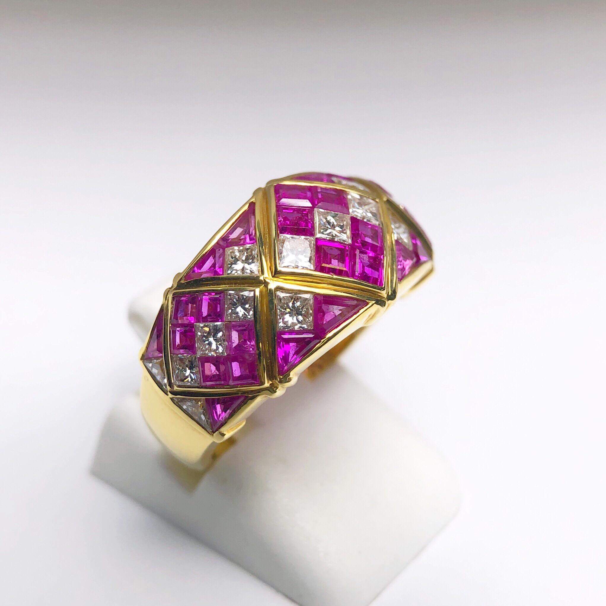 Designed with 4.78 carats of square calibre cut Pink Sapphires and 1.20 carats of princess cut White  Diamonds, this vintage ring remains timeless. Set in 18 karat yellow gold, the stone portion of the ring  measures approximately 7/8
