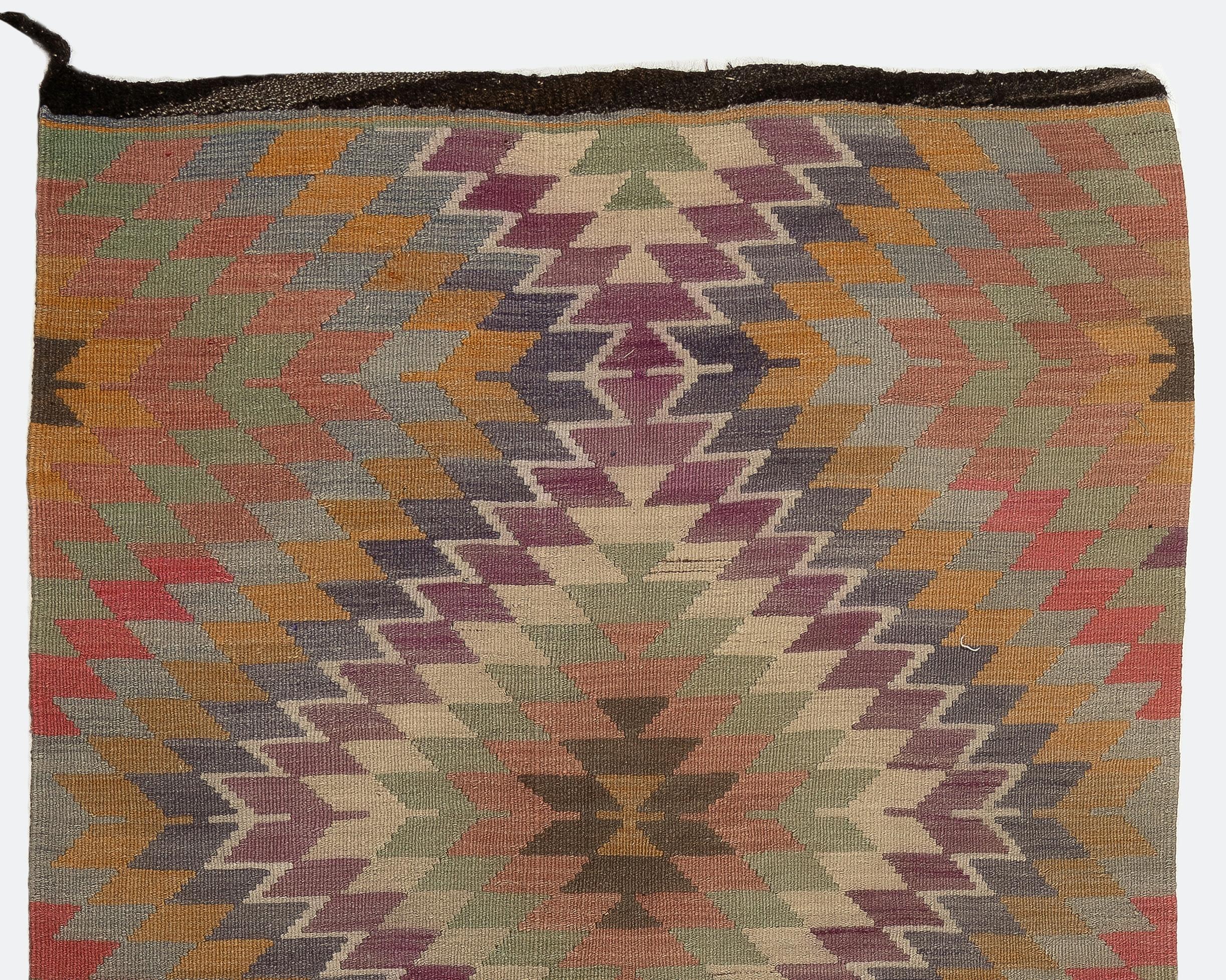 Vintage handwoven flat-weave (kilim) runner with a design of nested stepped diamonds in soft earthy tones. Made of 100% wool. Size: 4.7 x 11 ft.
Reversible; both sides can be used. Lightweight, easy to pick up and lay down.
Ideal for both