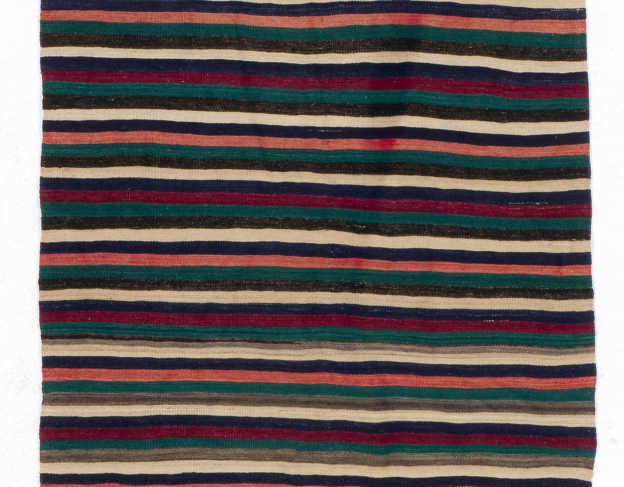 Colorful vintage handwoven flat-weave (Kilim) with striped design, 100% wool. Size: 4.7 x 11.8 Ft.
We can modify the dimensions if requested, i.e. make it shorter and/or narrower.
Reversible; both sides can be used. Sturdy and in good condition.