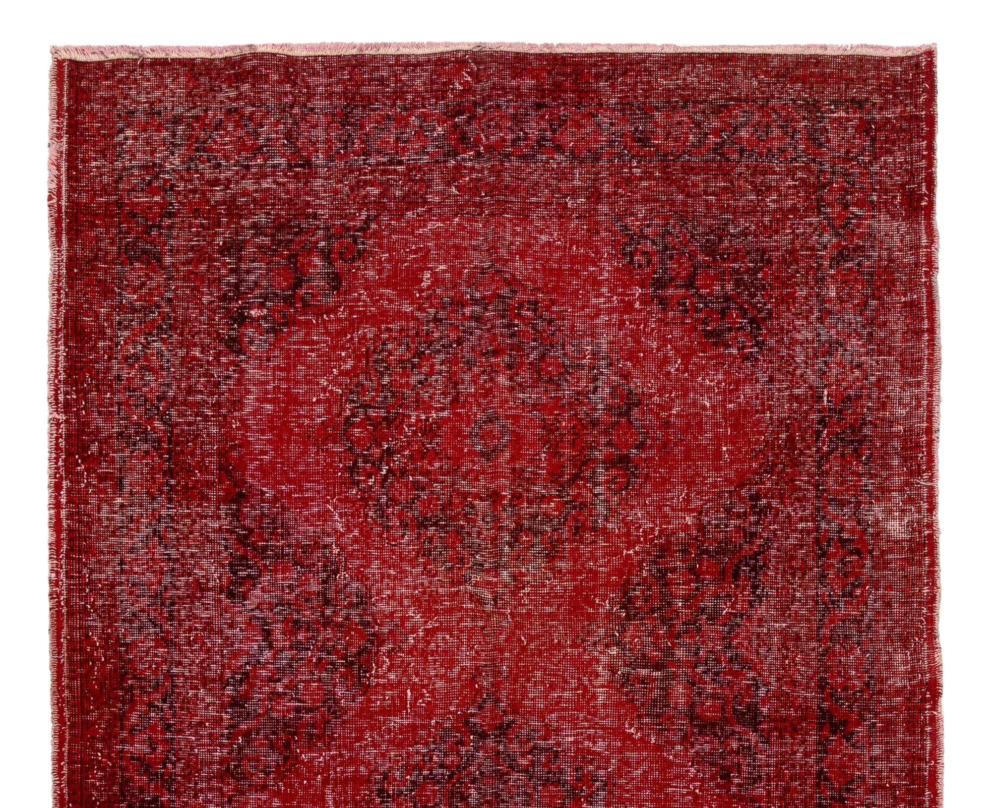 A vintage Turkish runner rug with a linked medallions design over-dyed in a deep, rich red, great for bringing a pop of color and a festive feeling to contemporary interiors.

The rug is finely hand knotted in the 1960s with low wool pile on cotton