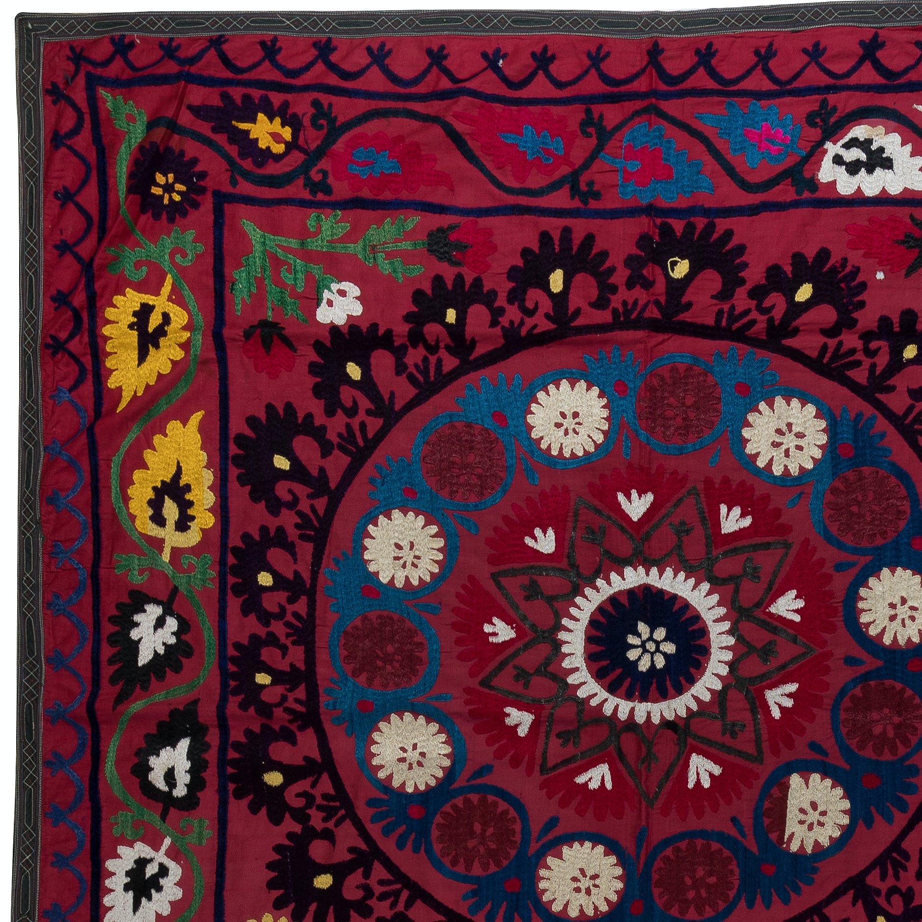 Step into a world of vibrant colors and intricate craftsmanship with our Uzbek Suzani Hand Embroidered Silk Wall Hanging or Bed Cover. This stunning piece is perfect for adding a touch of elegance to your home decor.

Made from a blend of silk and
