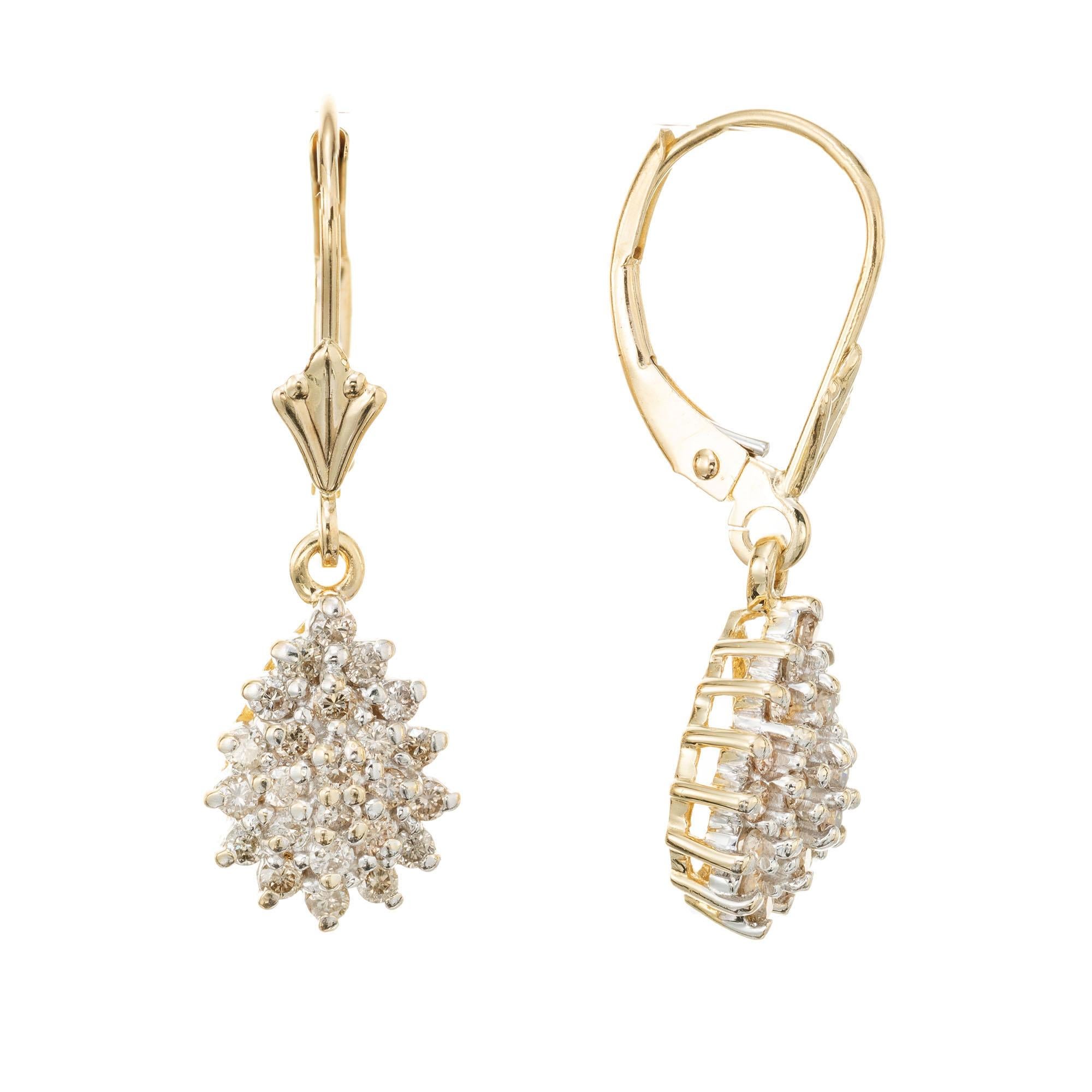 Dangle earrings in 14k yellow gold with domed pear shape clusters set with 48 round brilliant cut light brown tinted diamonds.

48 round brilliant cut diamonds, K-M VS-SI approx. .48cts
14k yellow gold 
Stamped: 14k
2.8 grams
Top to bottom: 2.7mm or