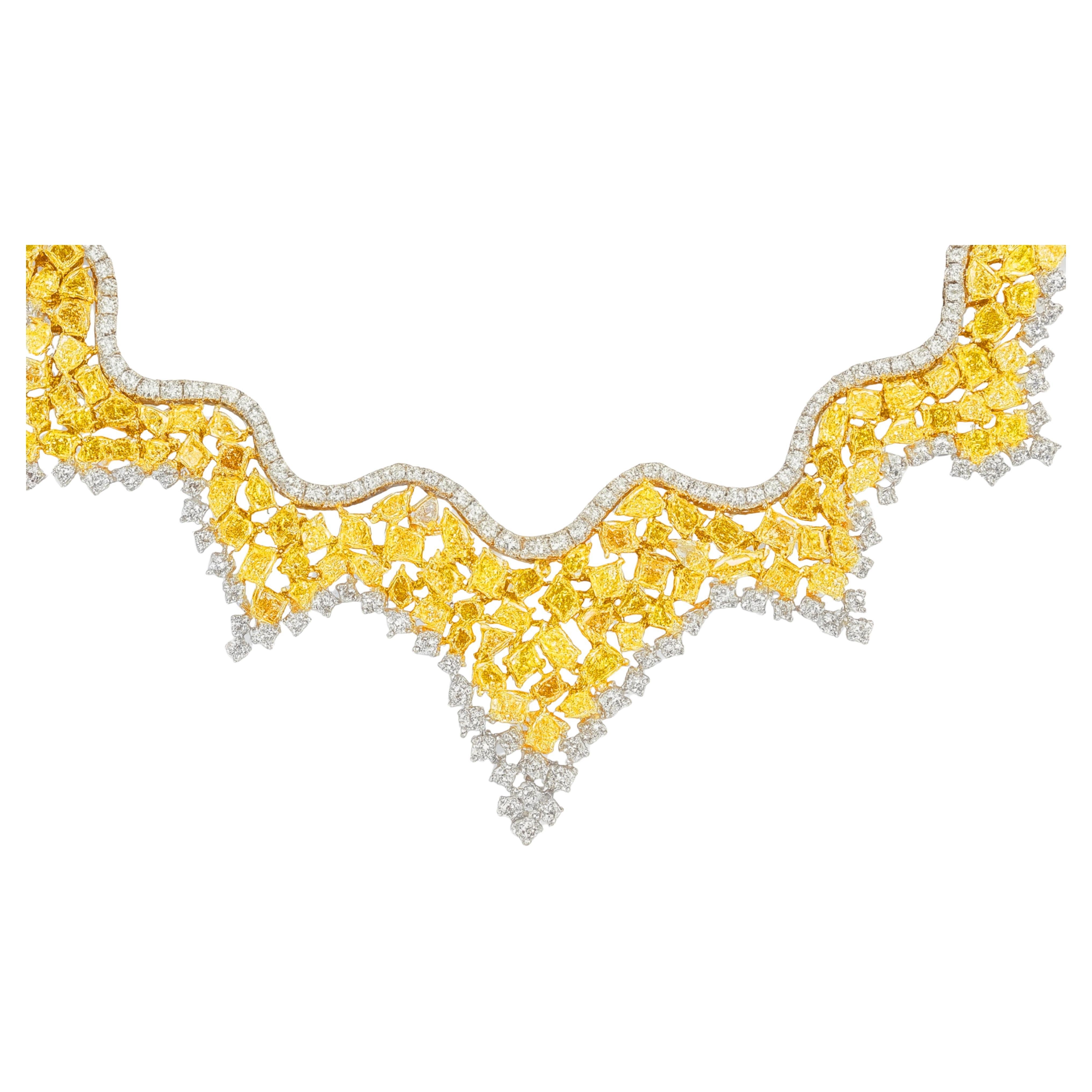 Natural Fancy Yellow Canary Diamond Art Deco Cluster Collar Necklace

A breathtaking statement of elegance and sophistication, this Art Deco–inspired collar necklace showcases an extraordinary display of 48 carats of natural fancy yellow and white