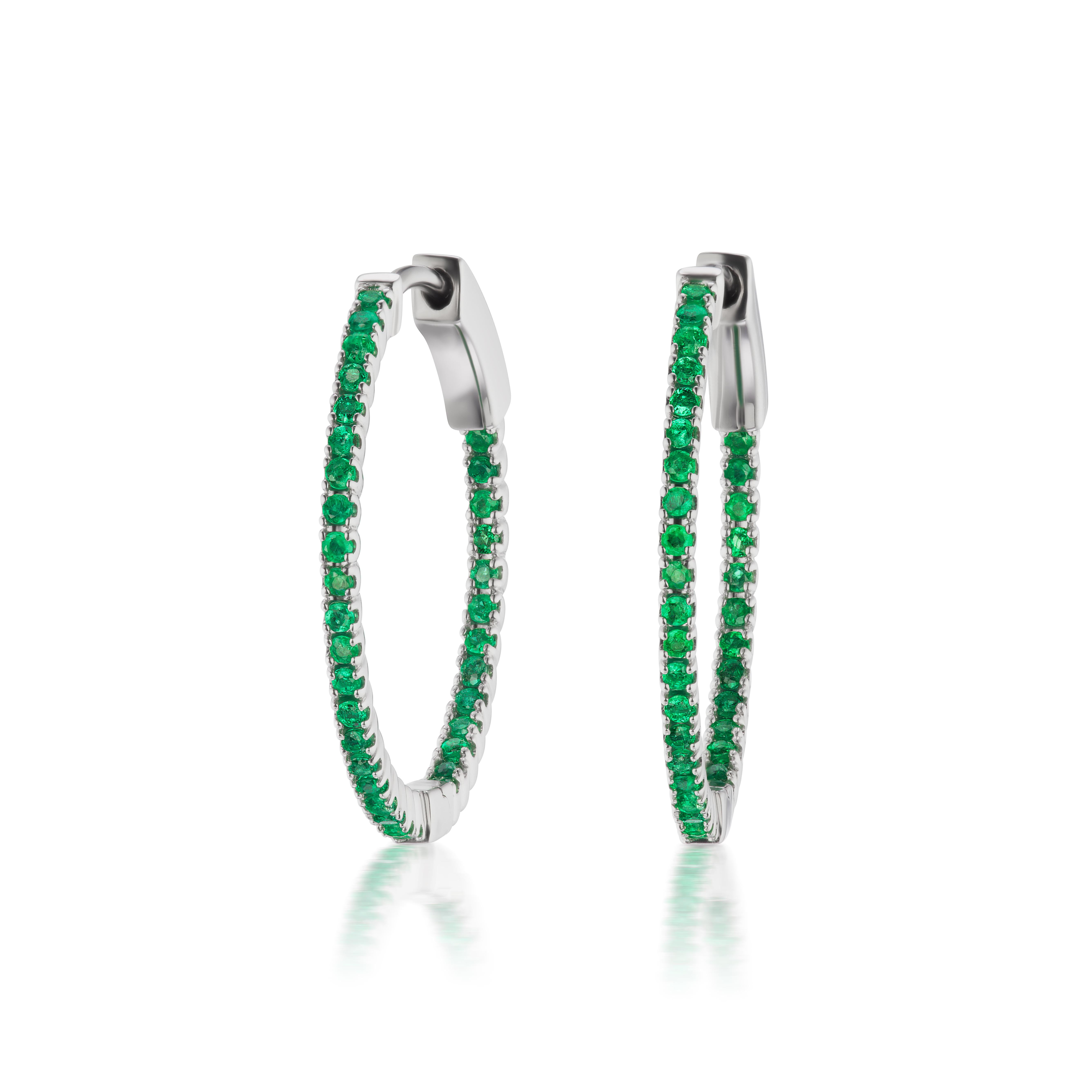 These Gemistry hoop earrings have the distinctive green glimmer of the emerald. Gleaming from the inside and outside, 0.48 ct. t.w. emerald rounds illuminate the polished 18k white gold hoops. 
Hanging length is 3/4”.
Please follow the Luxury Jewels