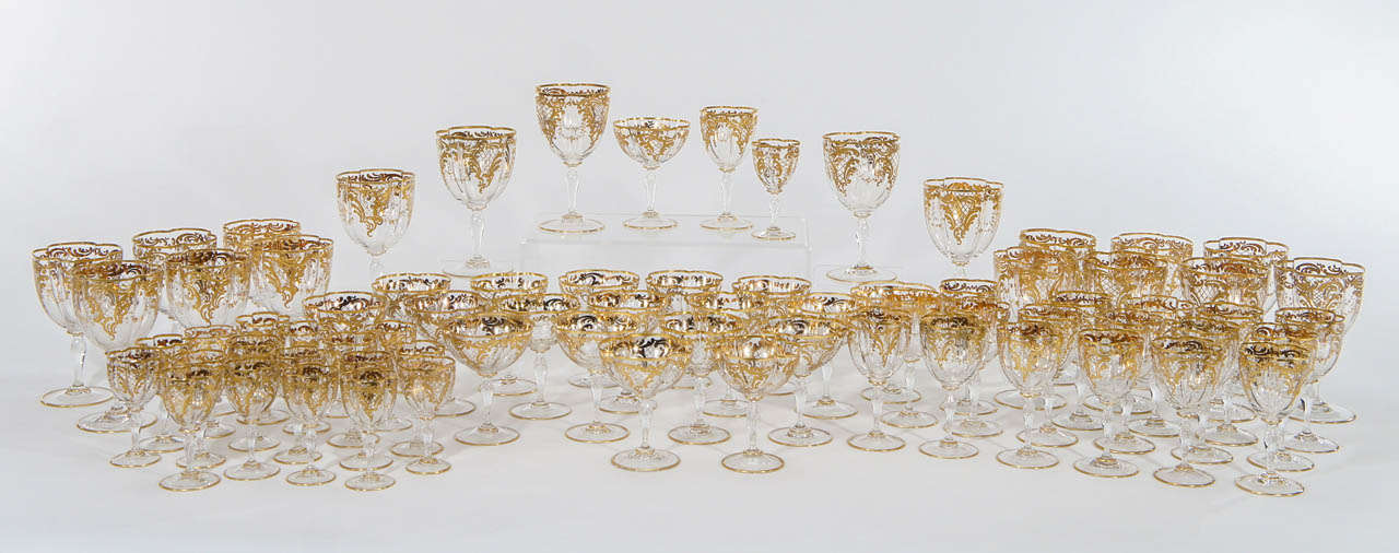An amazingly complete service for 12 hand blown crystal stemware with quatrefoil shaped bowls, each one embellished with raised paste gold enamel decoration in an Art Nouveau style.
The elegant service is perfect for today's table as each size is
