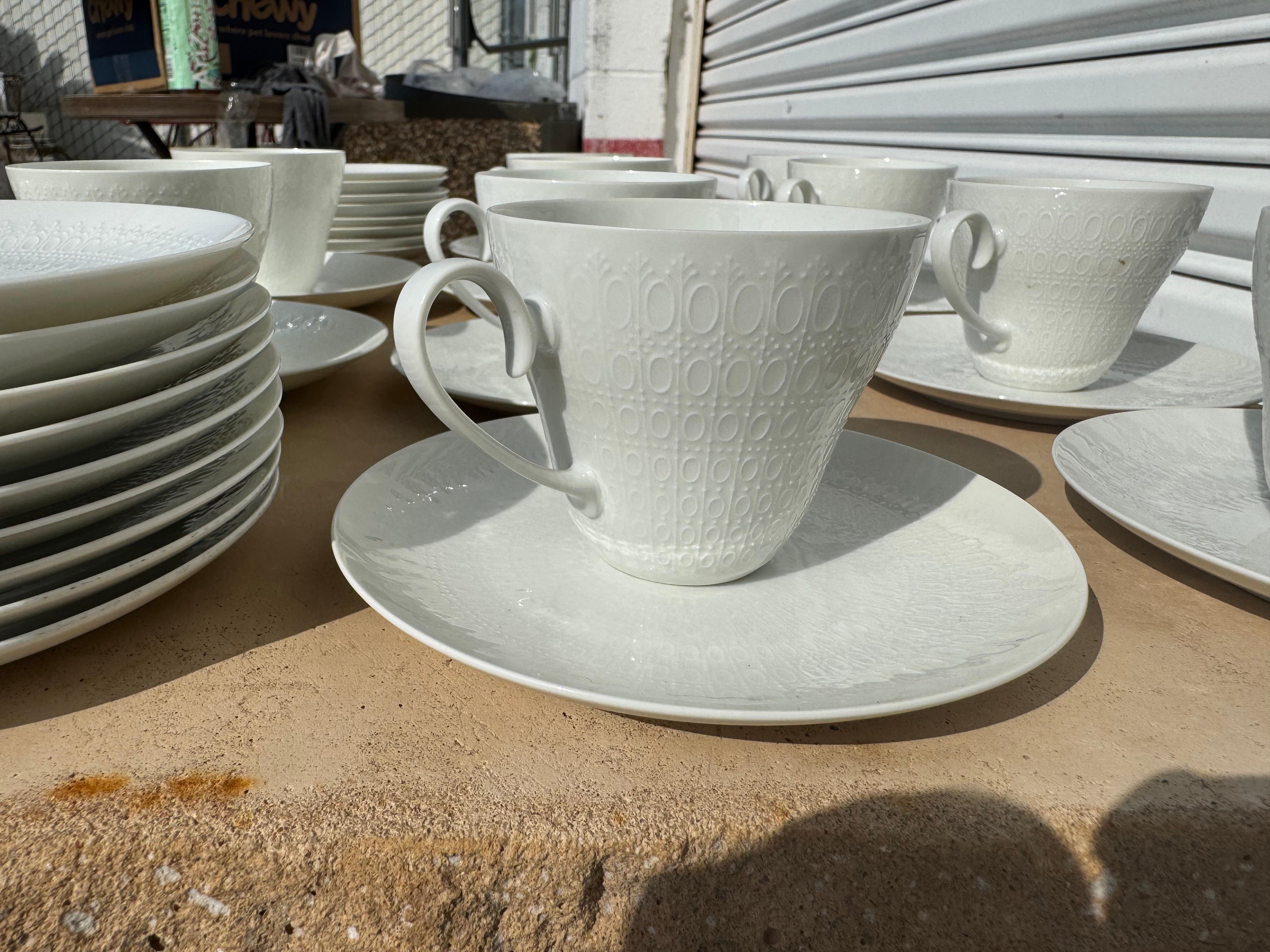 This is a nice set of dinner ware by Rosenthal.
The set is called the Motif Collection which was designed by Bjorn Wiinblad.
It has a lace pattern in a soft white.
Its a fine bone china that includes:
27 cup saucers 
11 tea cups
9 dinner plates
1