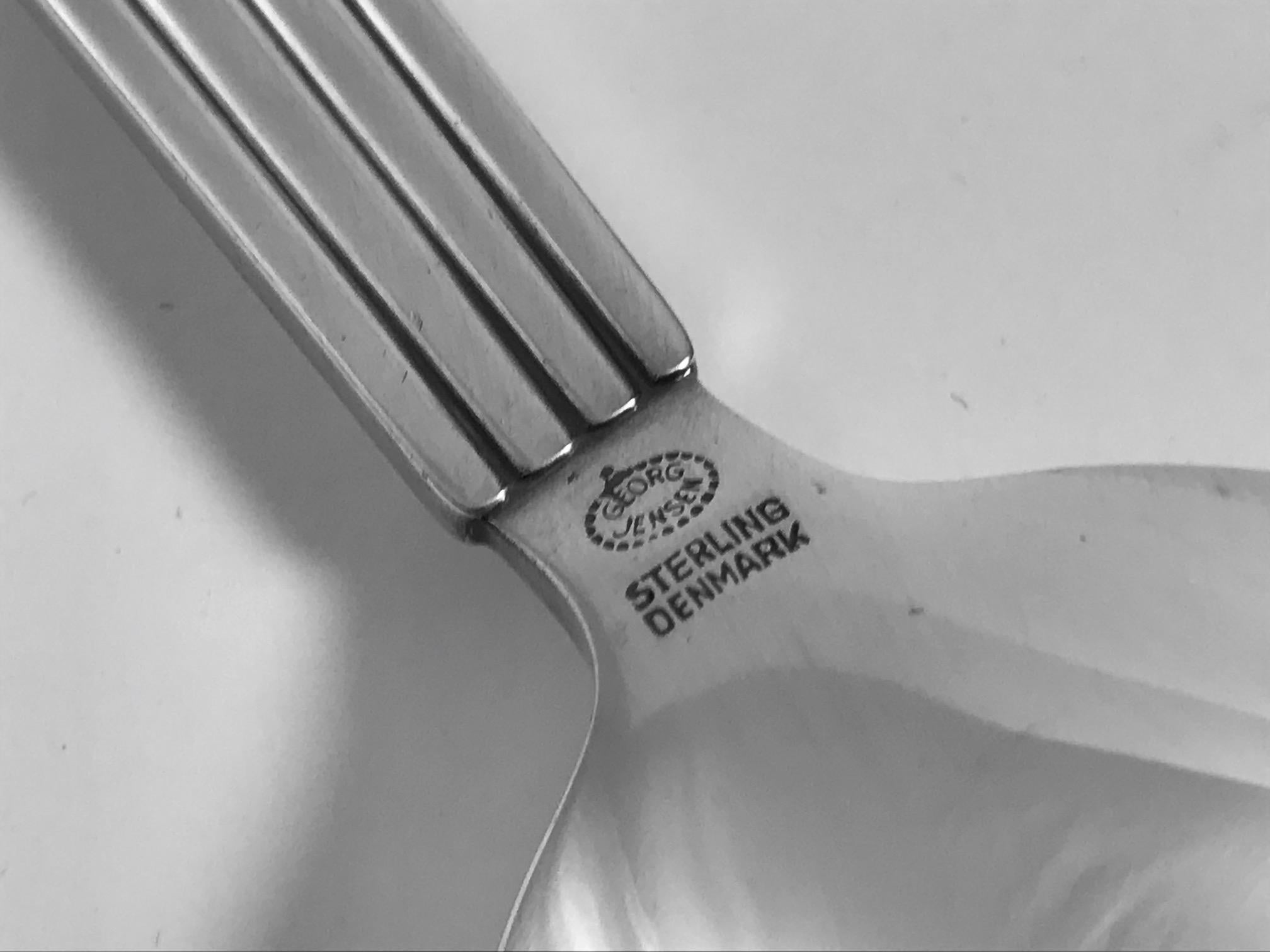 A Georg Jensen sterling silverware service in the Bernadotte pattern, designed by Sigvard Bernadotte in 1939. This set comprises eight settings, each setting of six pieces.

This set includes:
8 dinner knives, long handles, 8 dinner forks, 8