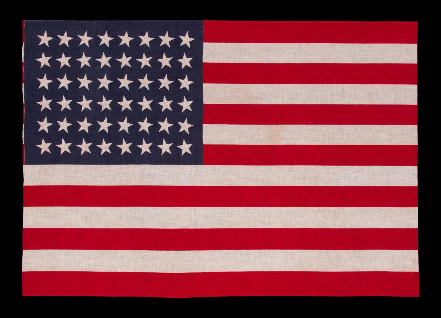 48 STARS IN DANCING ROWS, A RARE VARIETY OF ANTIQUE AMERICAN PARADE FLAG IN A LARGE SCALE, 1912-1918 OR PERHAPS EARLIER, ARIZONA & NEW MEXICO STATEHOOD:

In 1912, President Taft passed an executive order that dictated, for the first time, an