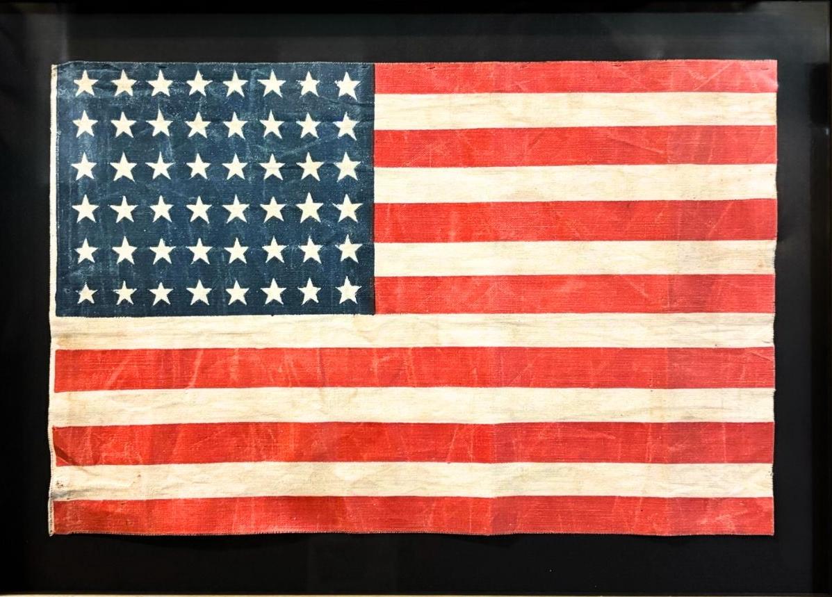 This is an original 48-star American parade flag, celebrating Arizona statehood. A wonderful product of our nation's early history, this flag is an authentic antique, with a fly date of 47 years, from July 4, 1912 to July 3, 1958. 
Prior to the