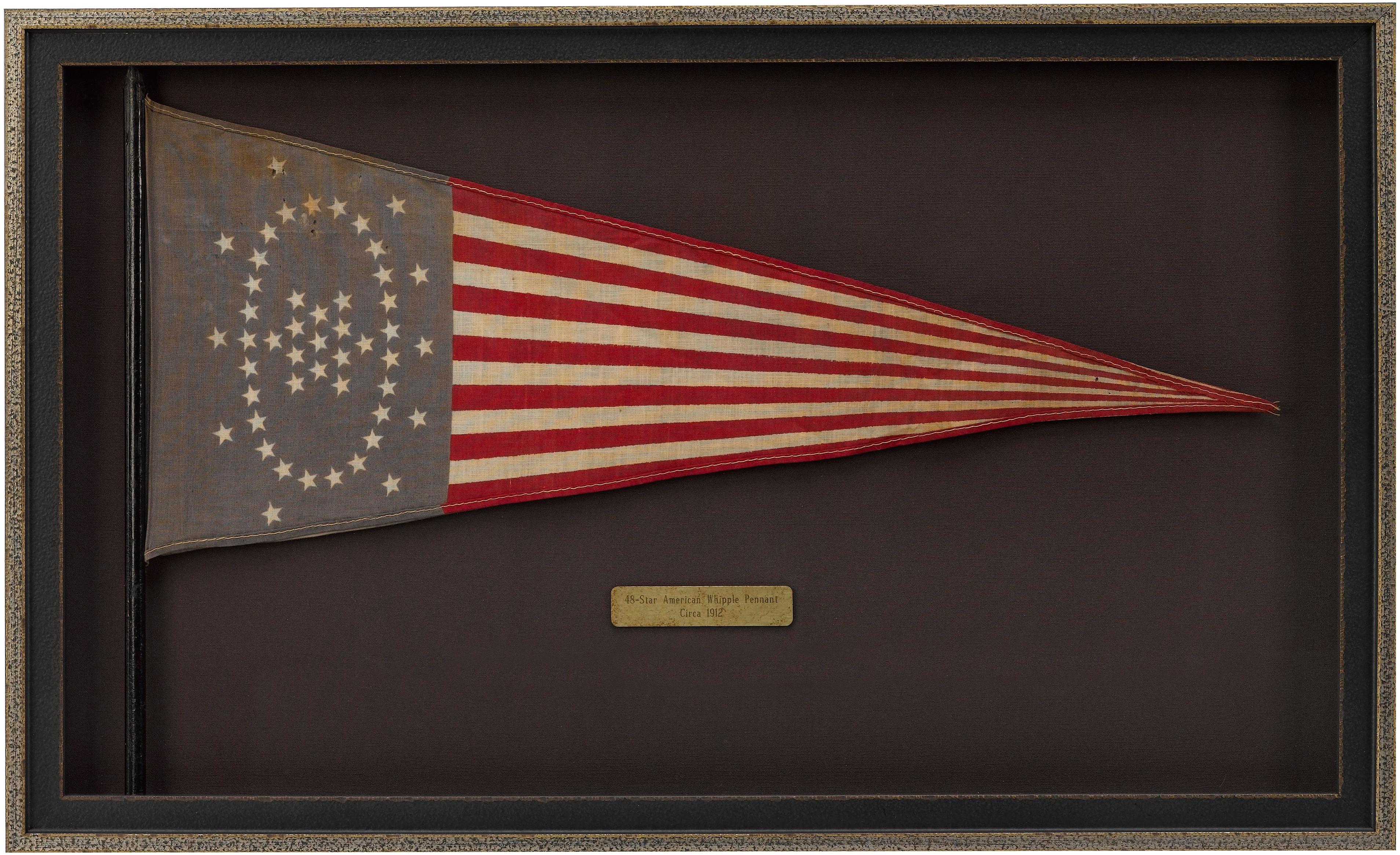 This is a beautiful example of a printed 48-star Whipple flag pennant. In the first decade of the twentieth century, a contest to design a classical style of American heraldry was held. The flag designed by Wayne Whipple, a well-known author of