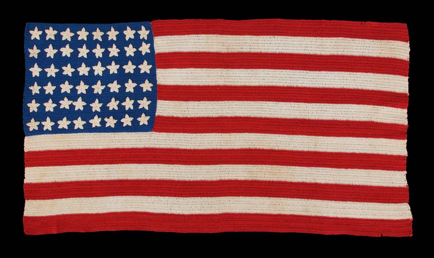 48 stars, crocheted, a beautiful example, WWI - WWII Era 

Beginning around the turn of the century, it became popular to make American flags from various forms of needlework, primarily by tatting and crochet. This one was probably made from a