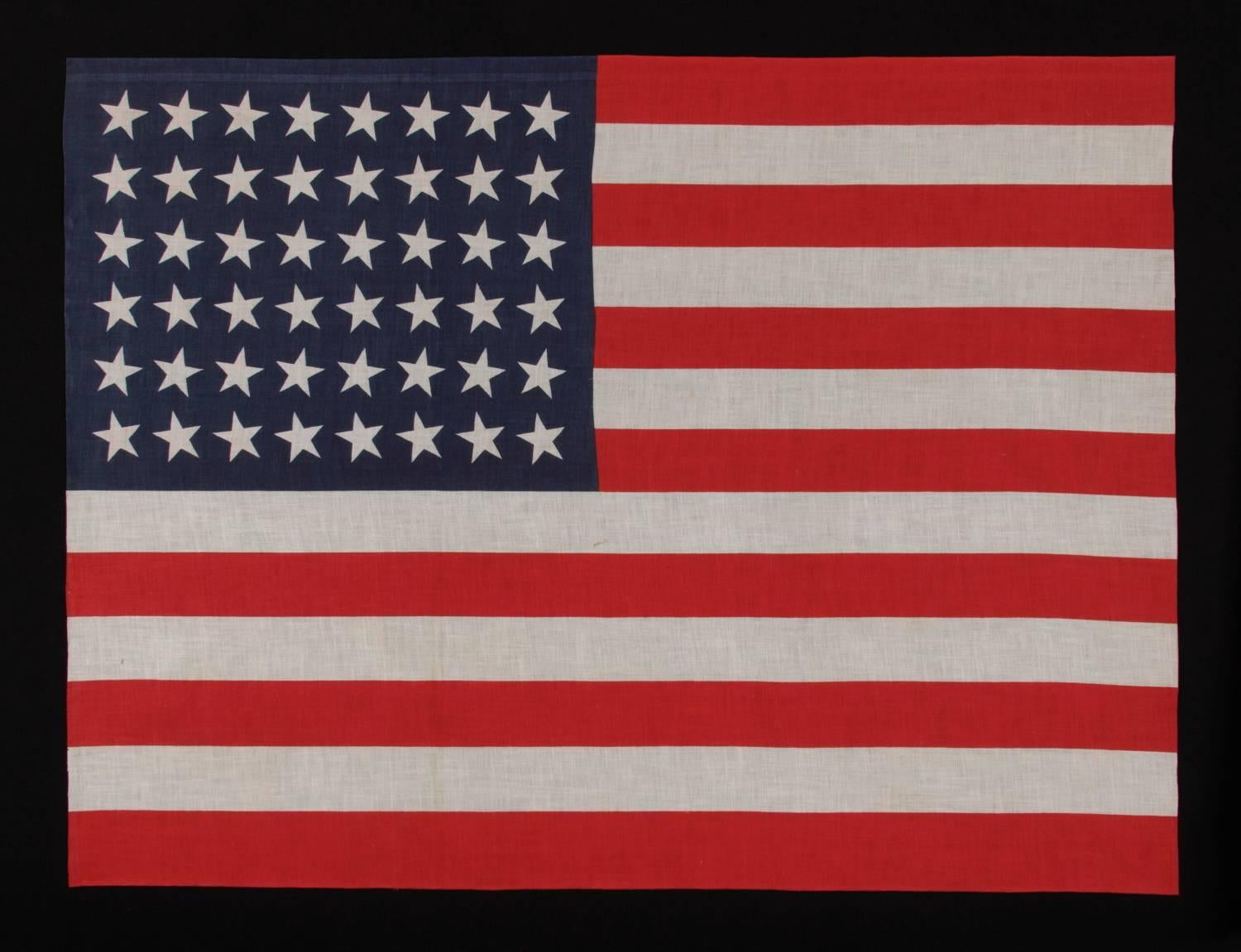 48 STARS IN DANCING ROWS, A RARE VARIETY OF ANTIQUE AMERICAN PARADE FLAG IN A LARGE SCALE, 1912-1918 OR PERHAPS EARLIER, ARIZONA & NEW MEXICO STATEHOOD  

In 1912, President Taft passed an executive order that dictated, for the first time, an