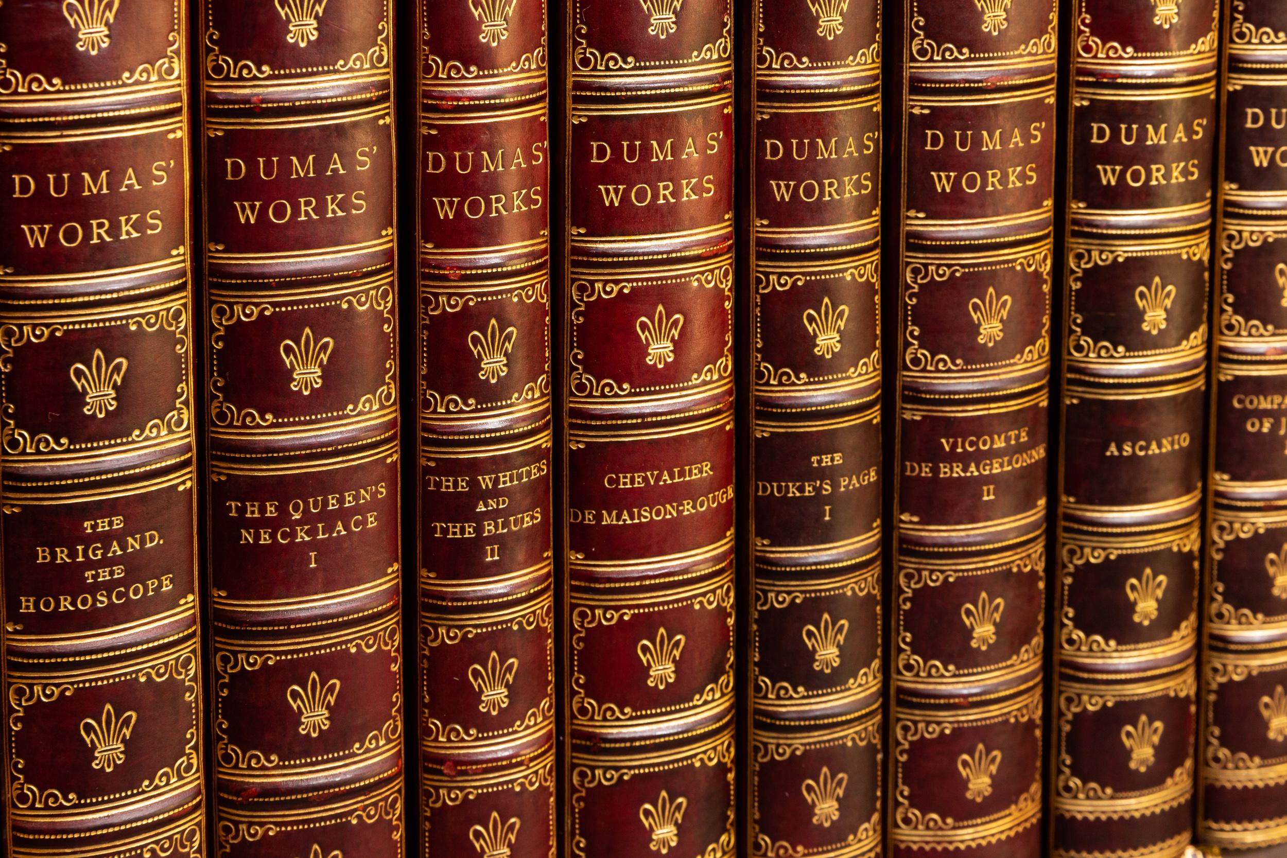 48 Volumes. Alexandre Dumas, Works of Alexandre Dumas. Bound by Bayntun in 1/2 red calf. Marbled boards. Marbled endpapers. Raised bands. Top edges gilt. Published: London; J.M. Dent & Co. 1906.