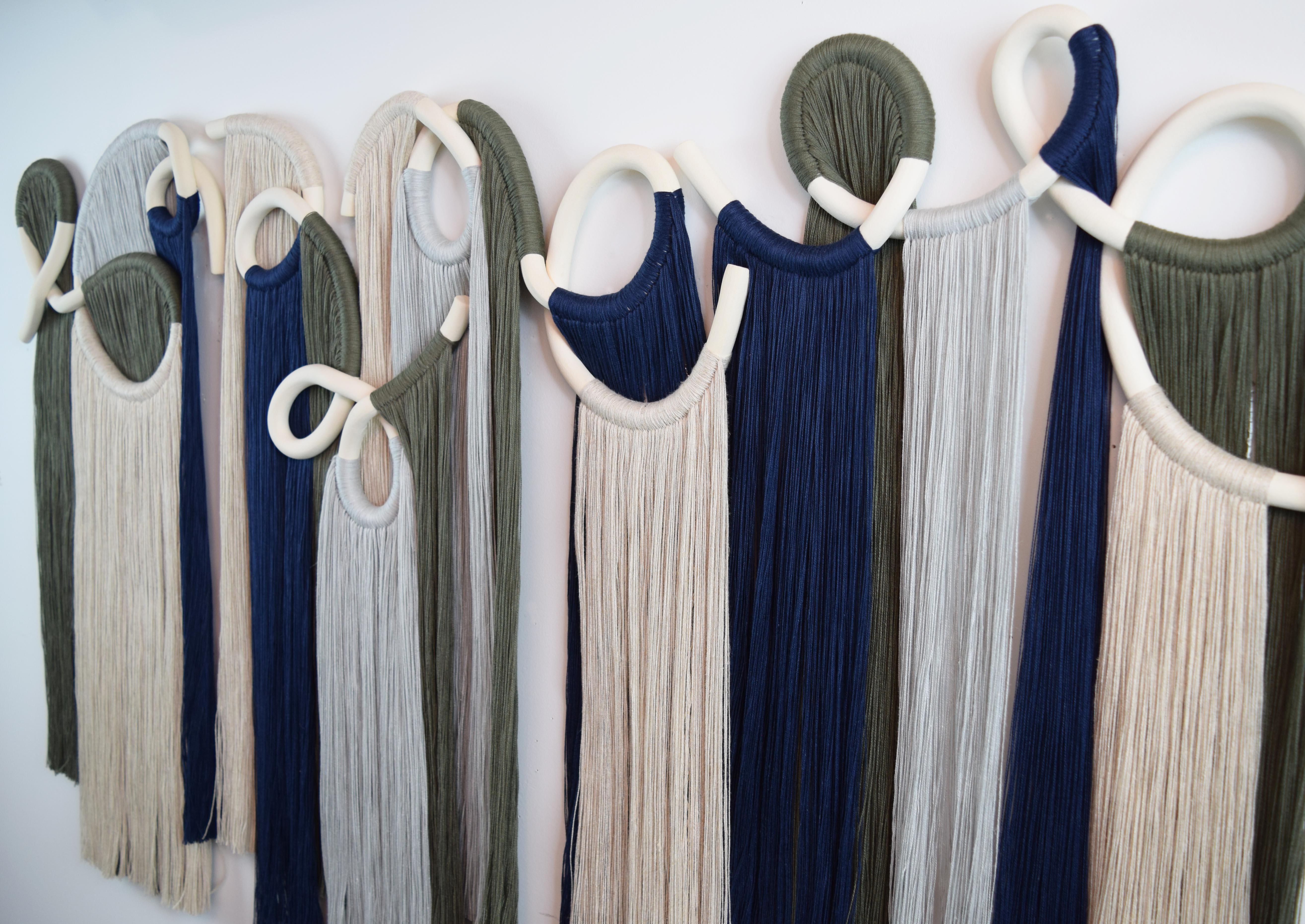 Four panel wall sculpture. Hand formed ceramic pieces in unglazed white stoneware with cotton fringe. Hanging wire is included on each panel. Ships with a small comb for fringe and installation instructions.

SIZE: 48”W x 30”H

Each piece is