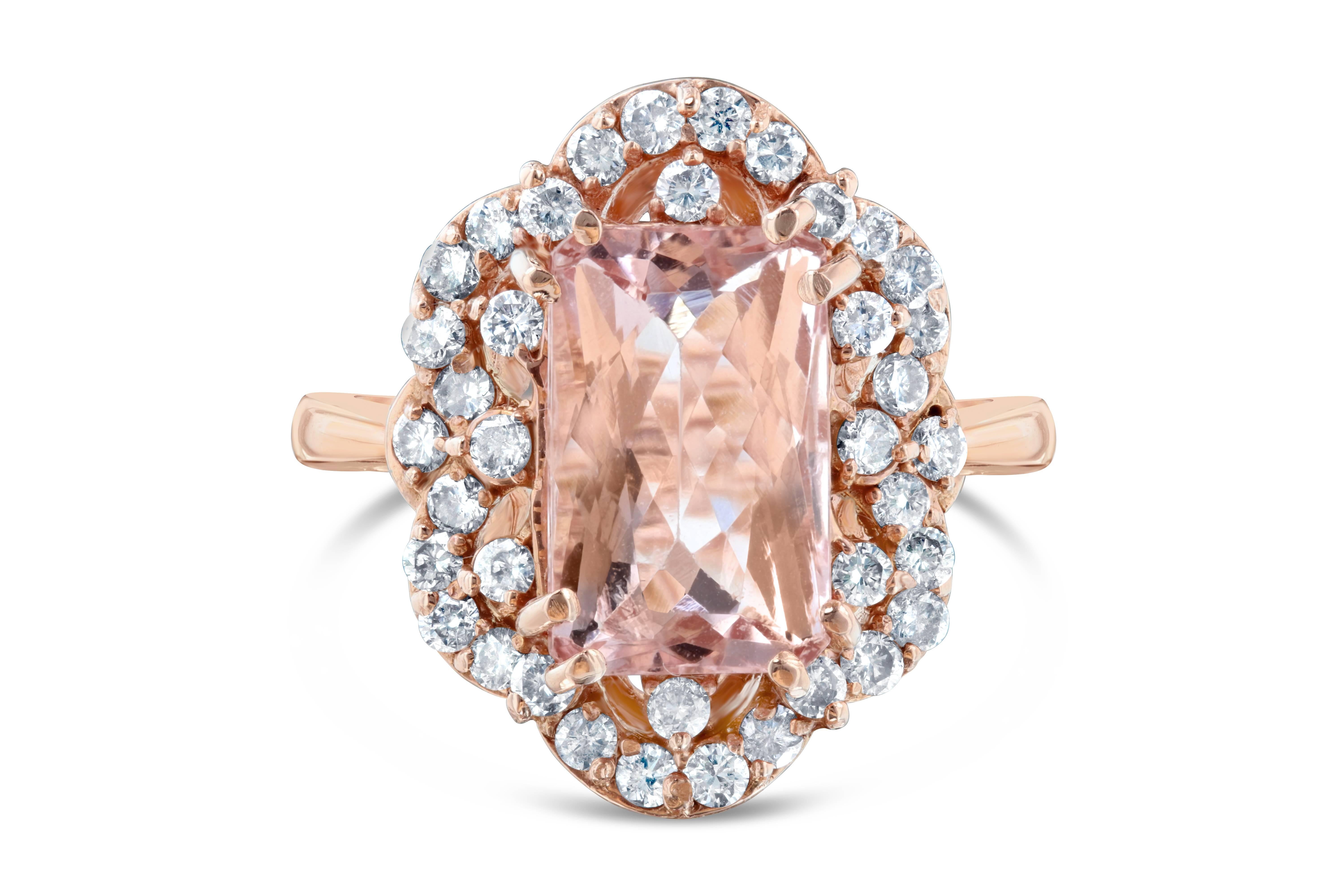A gorgeous Victorian Inspired ring! This ring has a 3.93 carat Rectangular Cut Morganite in the center of the ring and is surrounded by 38 Round Brilliant Cut Diamonds that weigh 0.87 carat. The ring is casted in 14K Rose Gold and weighs
