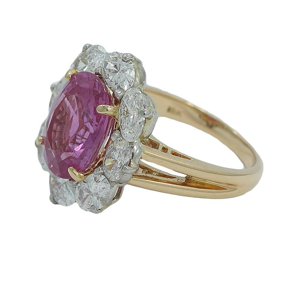 18K Yellow Gold and Platinum, Oscar Heyman Sapphire and Diamond Ring. It Has One (1) Cushion Cut Pink Sapphire Weighing 4.80 Carat Total Weight and Eight (8) Oval Cut Diamonds With F-G/VVS In Color and Clarity Weighing 2.28 Carats Total Weight. AGL