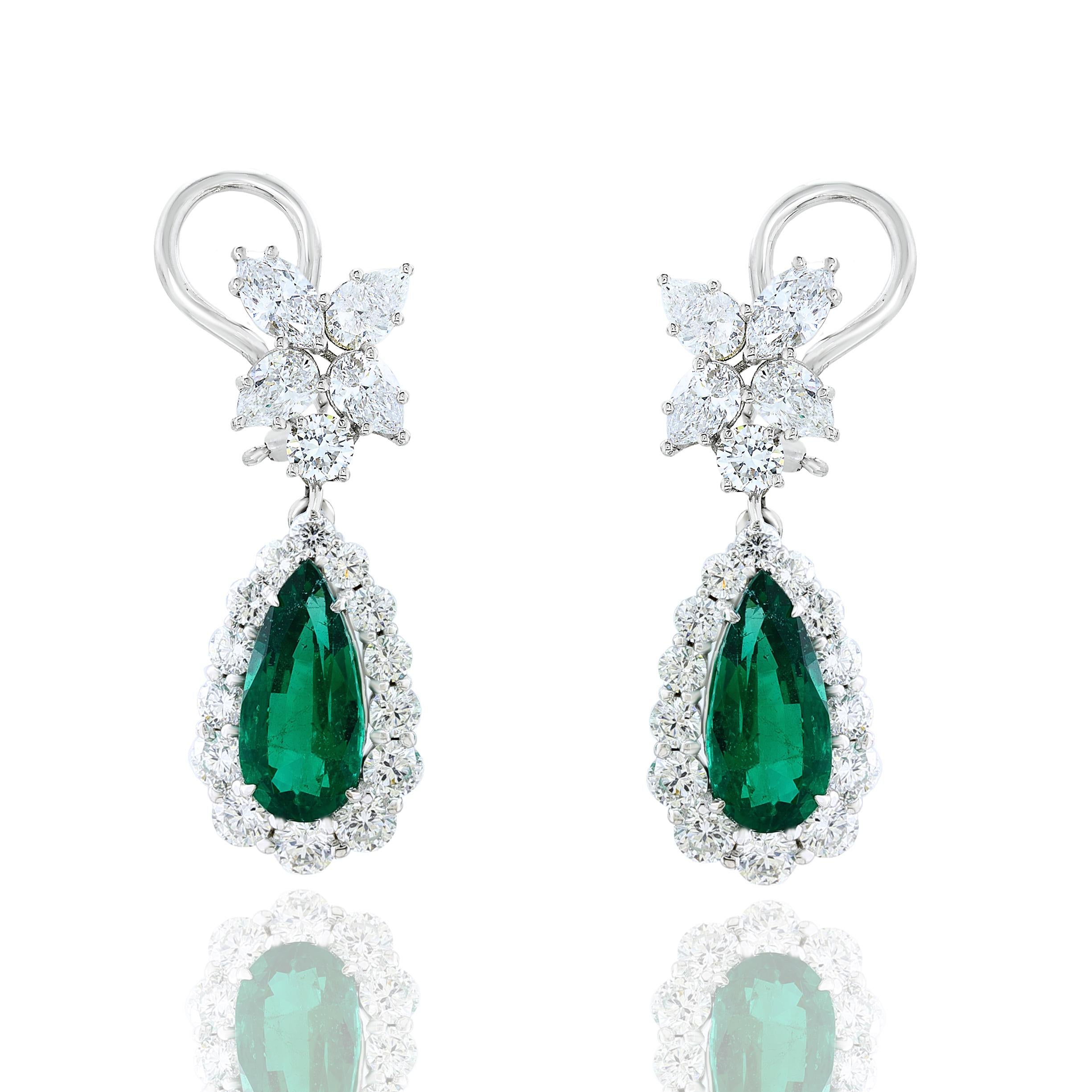 A beautiful and chic pair of drop earrings showcasing a cluster of brilliant mixed-cut diamonds, and pear shaped Emerald set in an intricate and stylish design. 8 Mixed cut Diamonds weigh 1.59 carats in total.   2 Emeralds weigh 4.80 carats in