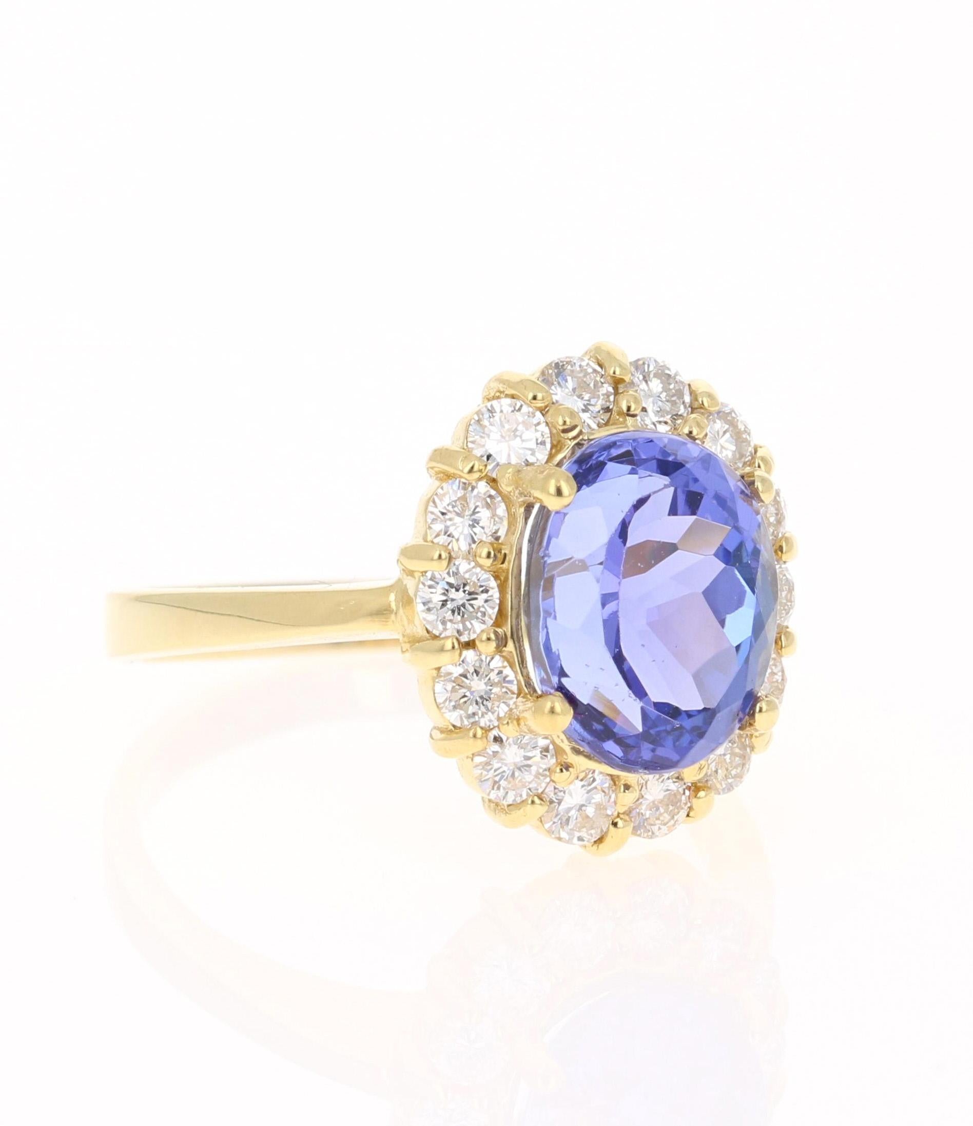 This beautiful ring has a vivid 4.02 Carat Oval Cut Tanzanite. The Tanzanite is surrounded by 14 Round Cut Diamonds that weigh 0.78 carats. (Clarity: VS, Color: H) The total carat weight of the ring is 4.80 carats. The Oval Cut Tanzanite measures at