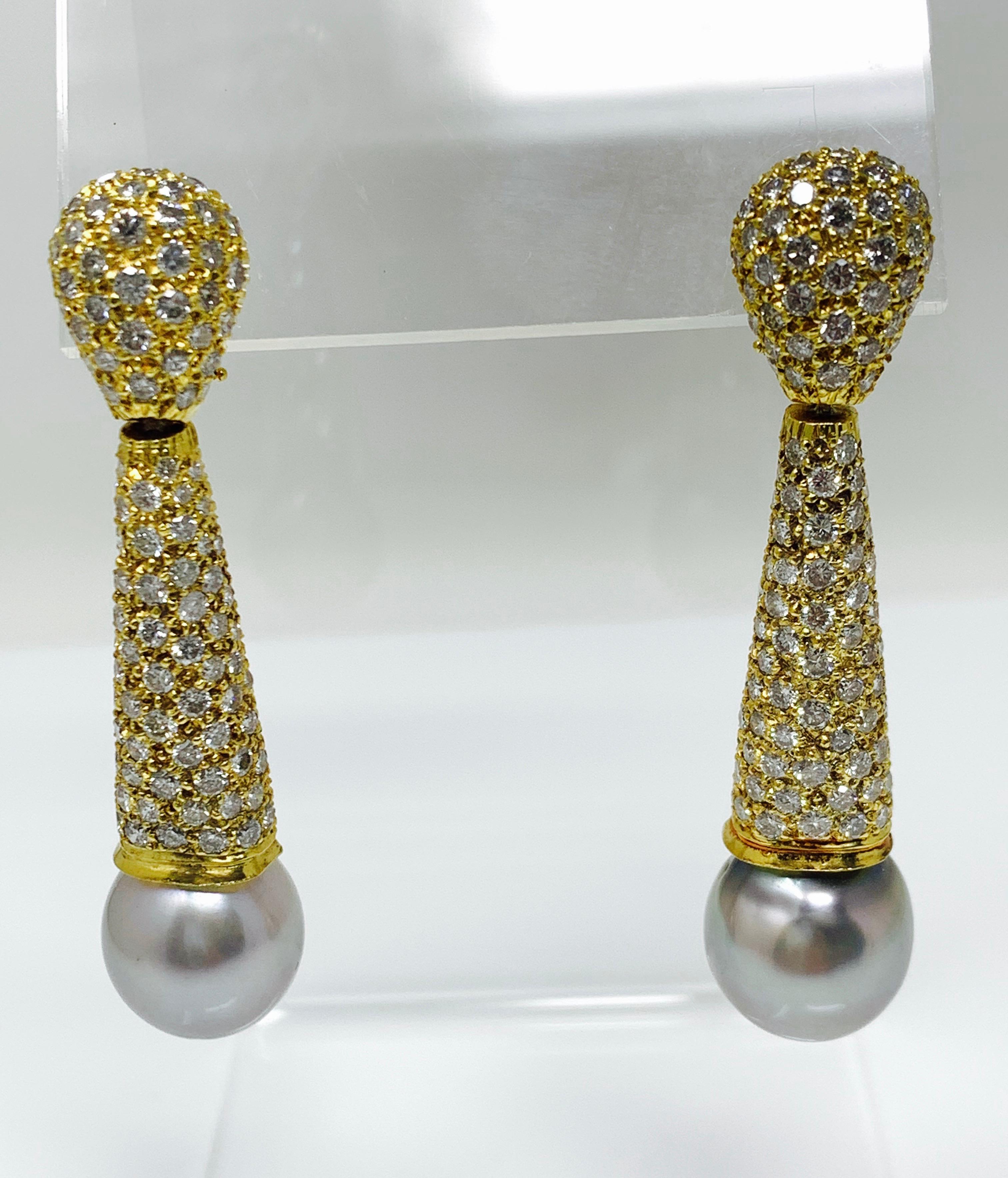 These gorgeous pave set white diamond and grey south sea pearl earrings are handcrafted in 18k yellow gold. 
The details are as follows : 
Diamond weight : 4.80 carat ( GH color and VS clarity ) 
South sea pearls : 12.6 mm each 
Metal : 18k yellow