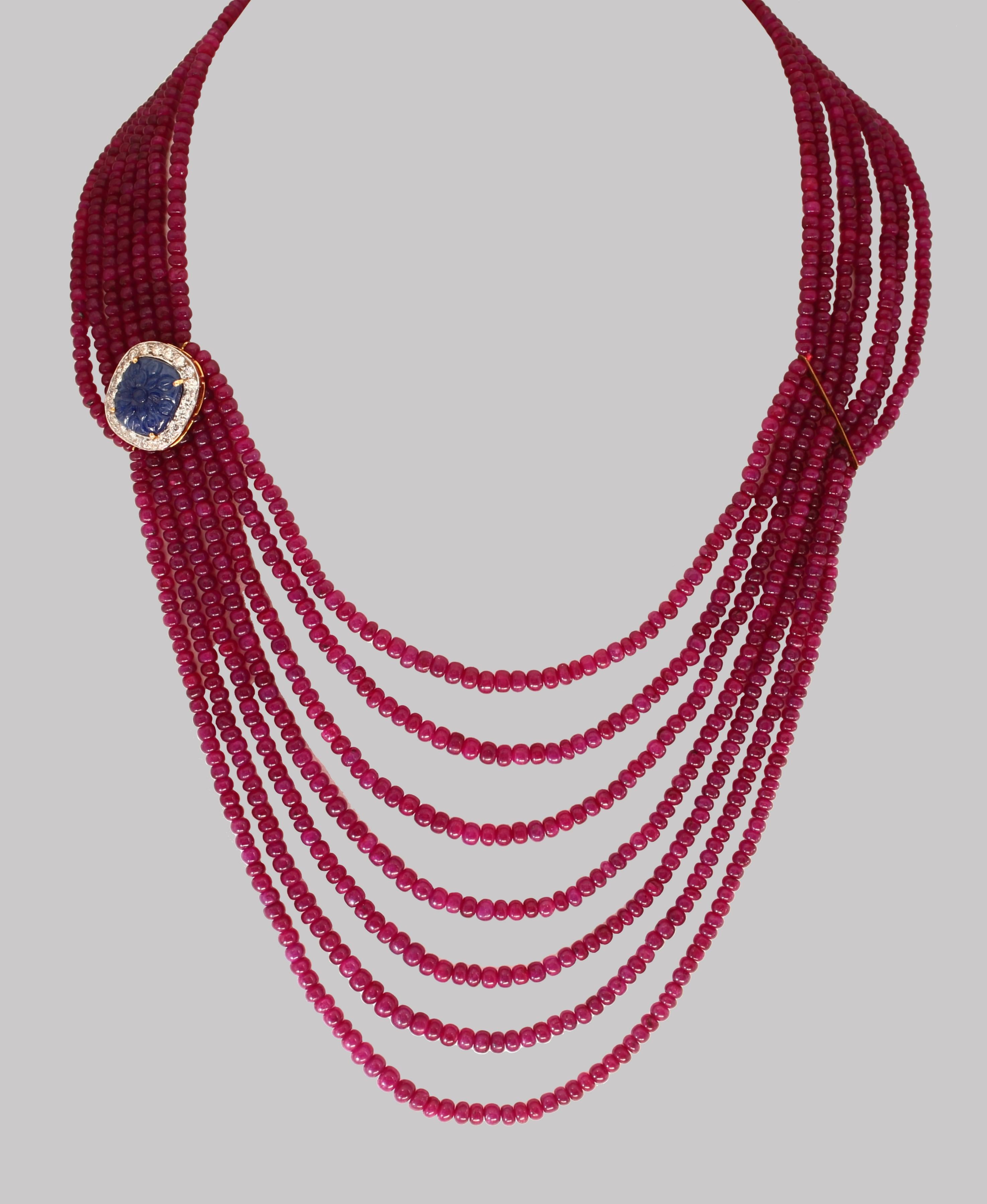 Approximately 480 Ct 7 Layer Smooth Natural Ruby Bead Necklace with 14 Karat Gold Clasp and carved sapphire and diamond spacer
This spectacular Necklace consisting of approximately 480 Ct of Fine and natural beads of ruby
A magnificent bead necklace