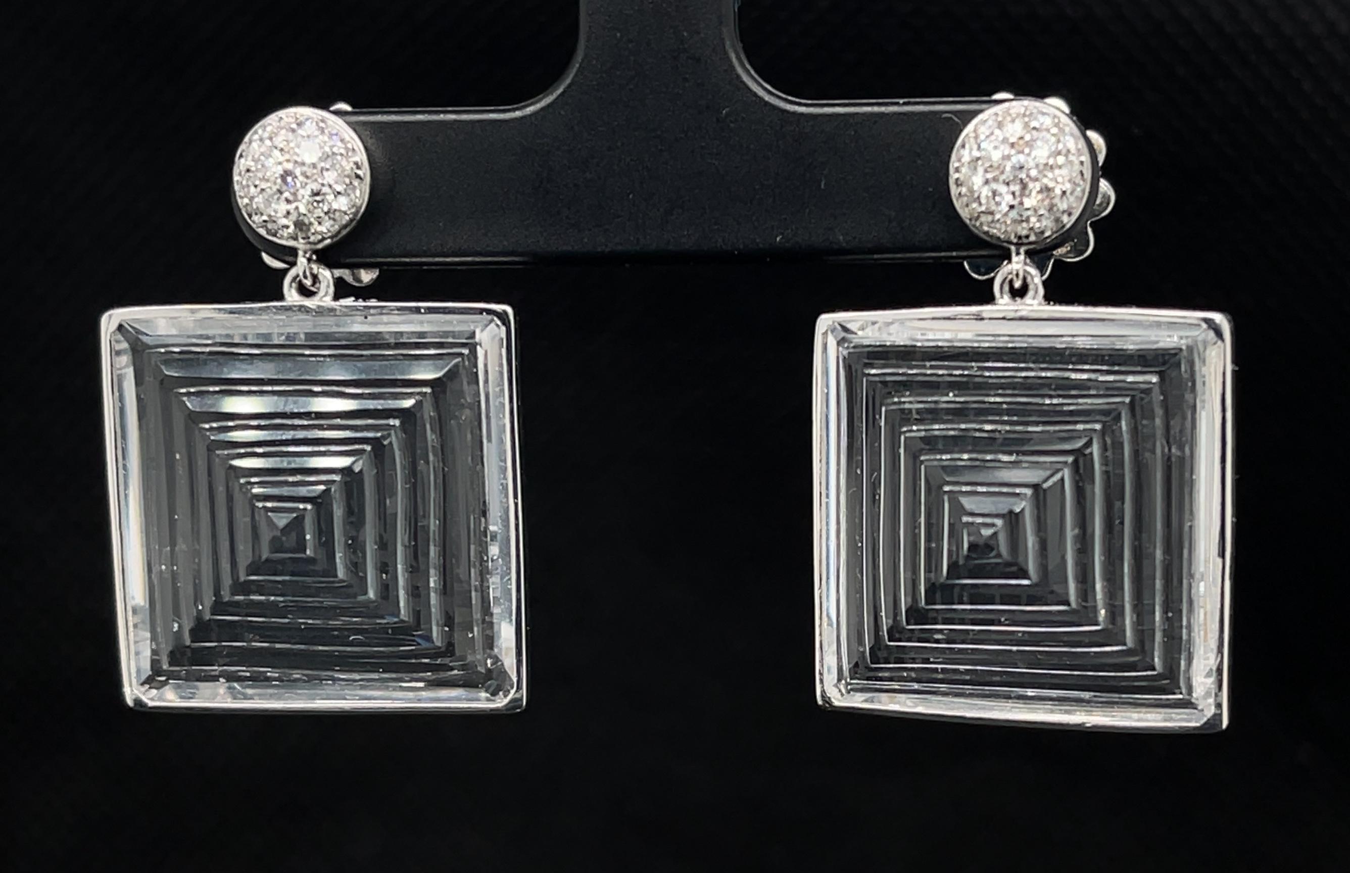 These fantasy pyramid cut earrings are ready to party! Sculpted from beautifully-matched, nearly transparent rock crystal quartz, these dangle earrings evoke a timeless, Art Deco style. The quality of workmanship and sparkling diamonds ensure they