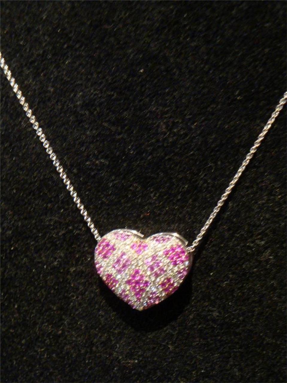 The Following Item we are offering is this Beautiful Rare Important 18KT White Gold Diamond, Ruby, and Pink Sapphire Heart Pendant Necklace. Necklace is comprised of approx 2 Carats of Fine Invisibly Set Glittering Diamonds with Rubies and Pink