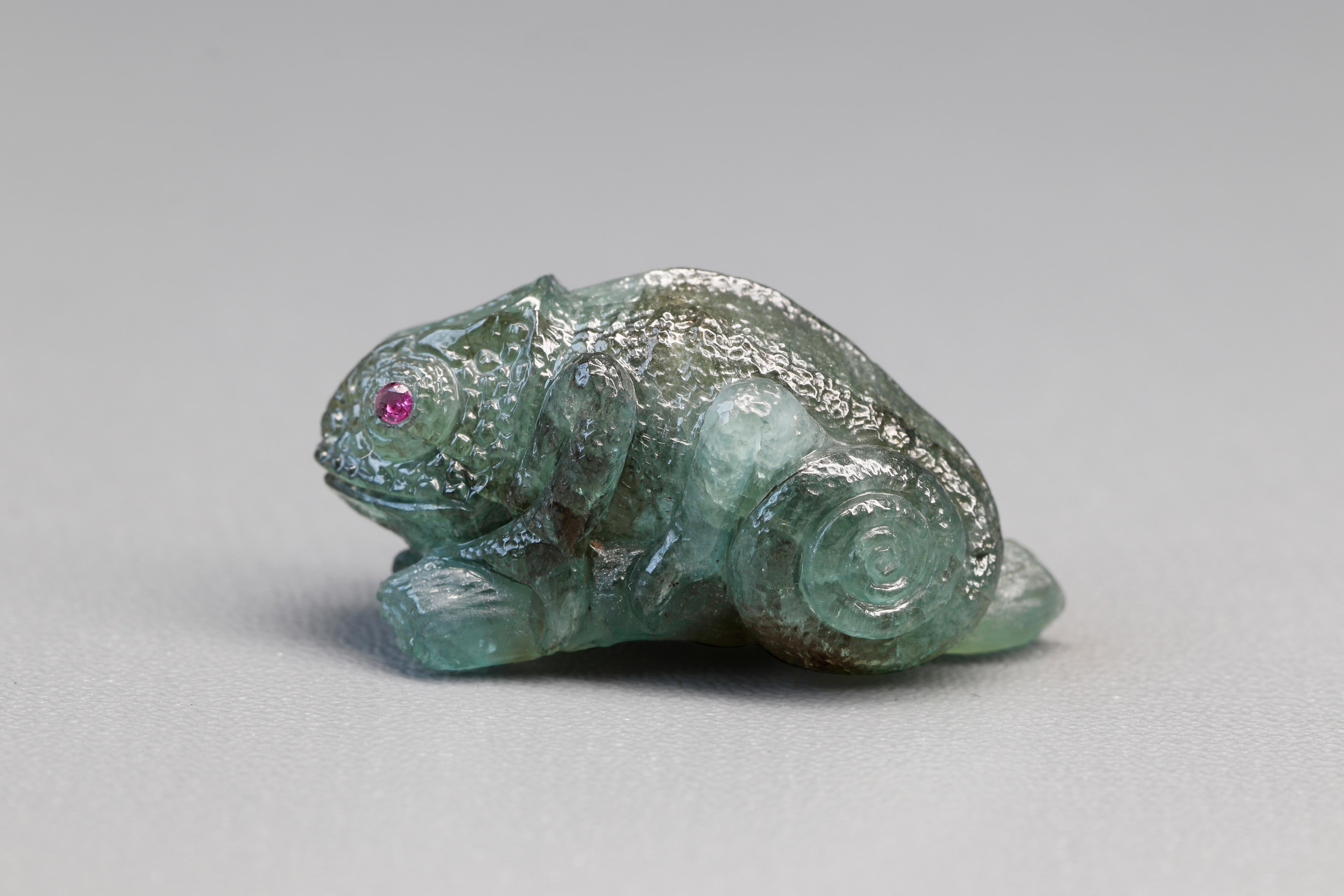 An extraordinary 48.02 ct Alexandrite carving, meticulously shaped into the form of a chameleon. Alexandrite, known for its remarkable color-changing properties, holds a rich historical significance. Discovered in the Ural Mountains of Russia in the
