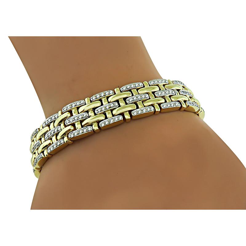 This is a fabulous 14k yellow and white gold bracelet. The bracelet is set with sparkling round cut diamonds that weigh approximately 2.70ct. The color of these diamonds is H with VS clarity. The bracelet measures 12mm in width and 7 inches in
