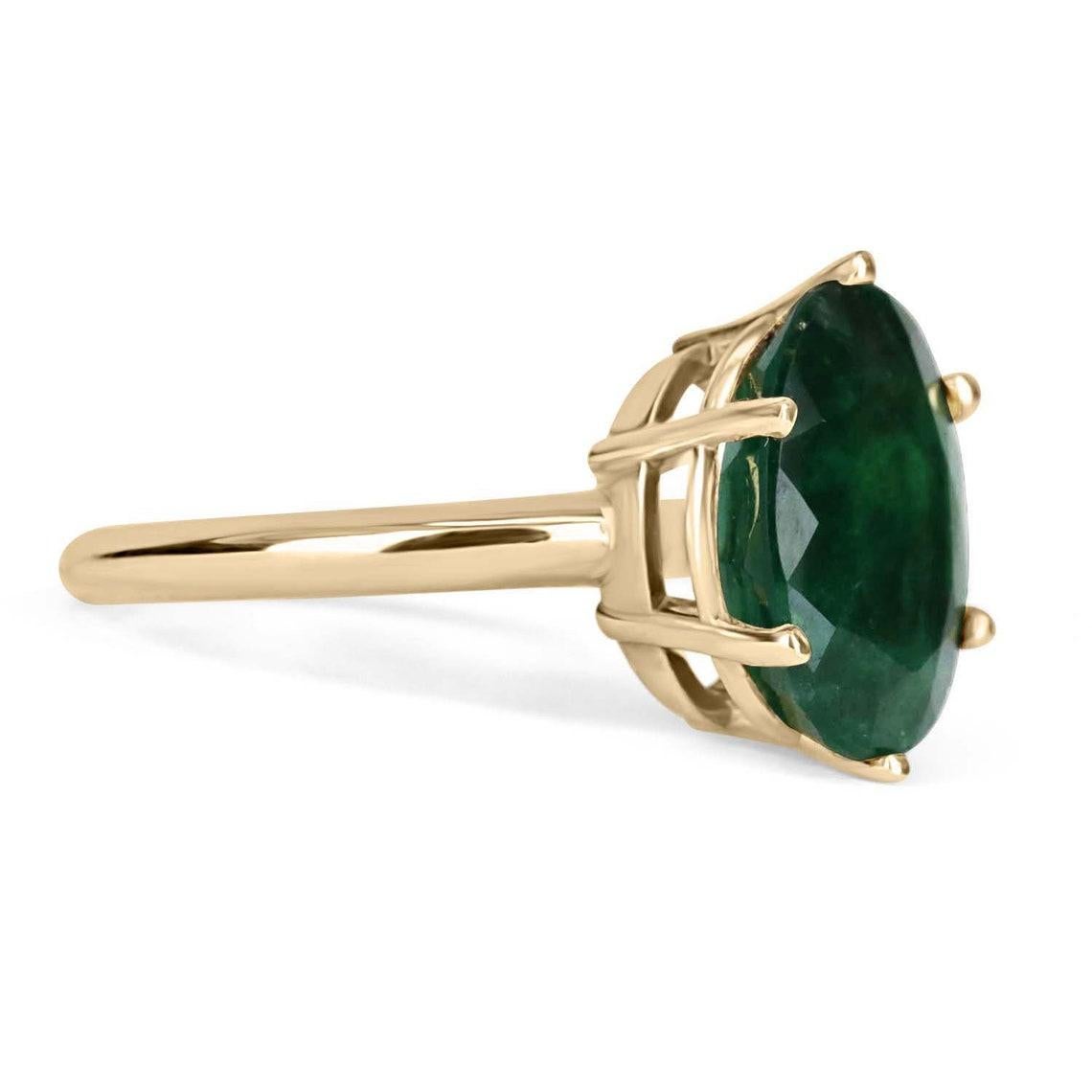Featured is a gorgeous solitaire emerald ring. The gemstone carries a full large 4.80-carats, displaying a lovely rare dark-green color and natural Jardin within the earth-mined stone. Set in a 14K yellow gold, 6-Prong, solitaire setting.

Setting