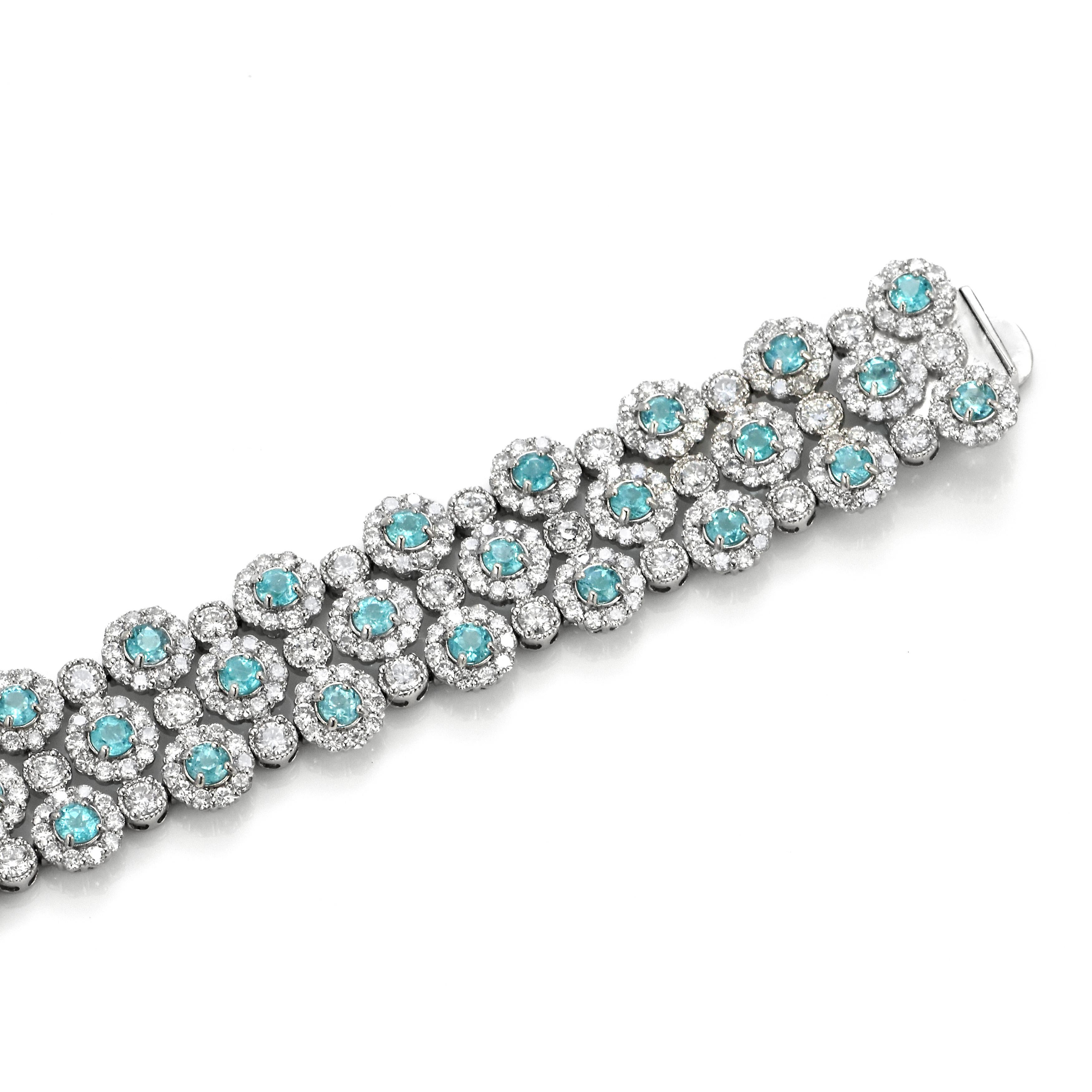 A beautiful 3-Line Bracelet featuring 4.81 Carats of Natural, Neon Blue Brazilian Paraiba Tourmaline and 8.46 Carats of Diamond Accents made in Platinum. Paraiba Tourmalines were only discovered 30 years ago in the Brazilian state of the same name-