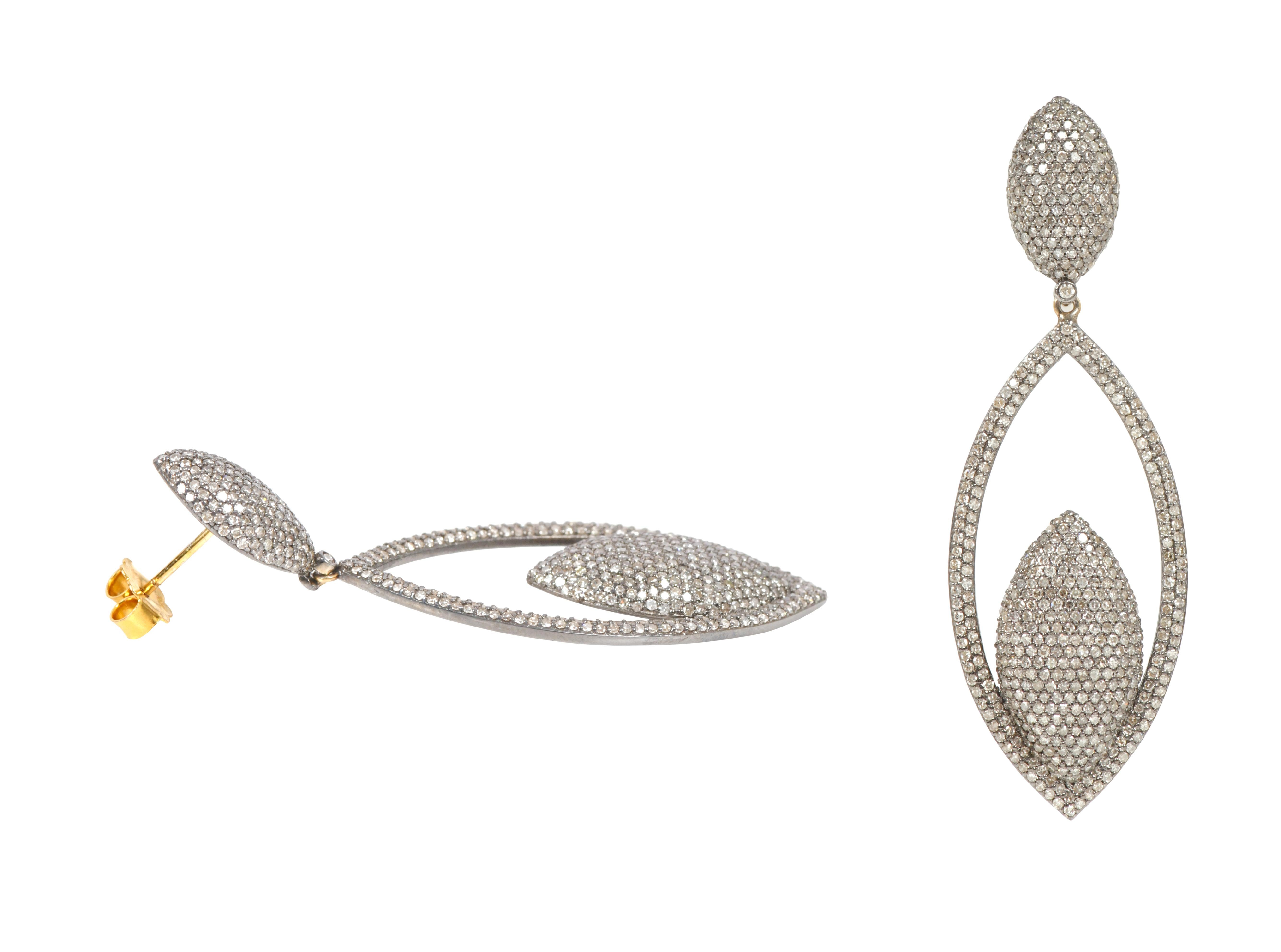 4.81 Carat Pave Diamond Cocktail Drop Earrings in Victorian Style

This Victorian art-deco style diamond pave set long earring is sensational. The open marquise shape is magnificently formed with two pave set diamond rows on the outside with various