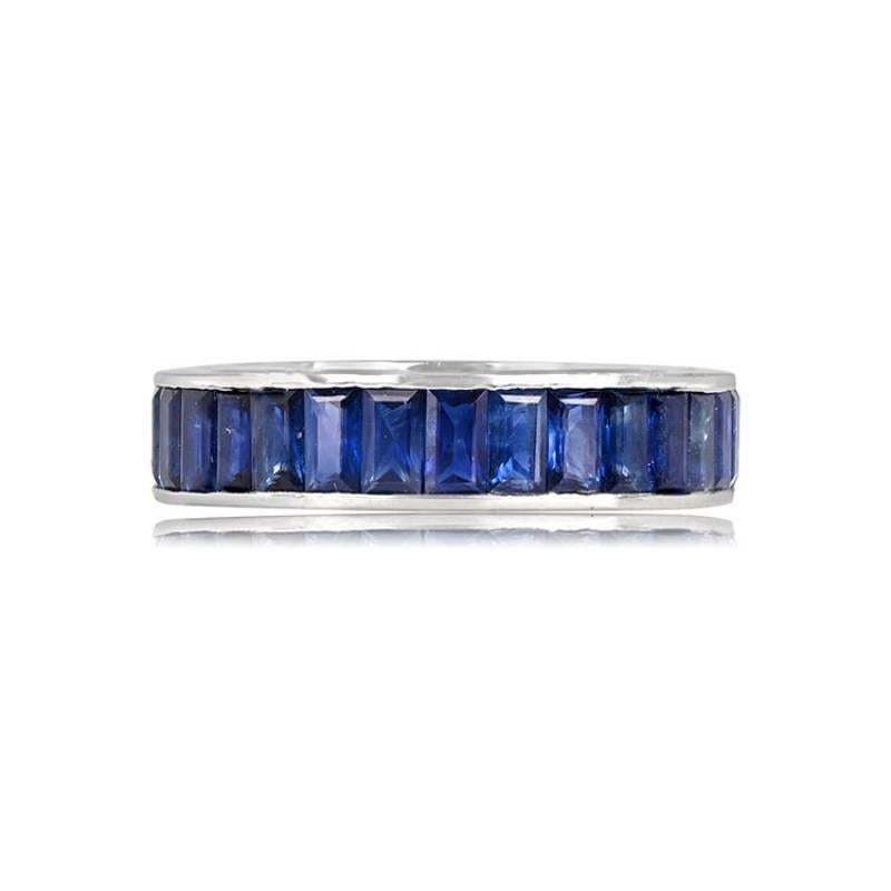 This platinum eternity band, measuring 4.60mm, boasts a stylish design with channel-set baguette-cut sapphires arranged in a north-south orientation. The combined weight of the sapphires is an impressive 4.81 carats.

Ring Size: 6.5 US,