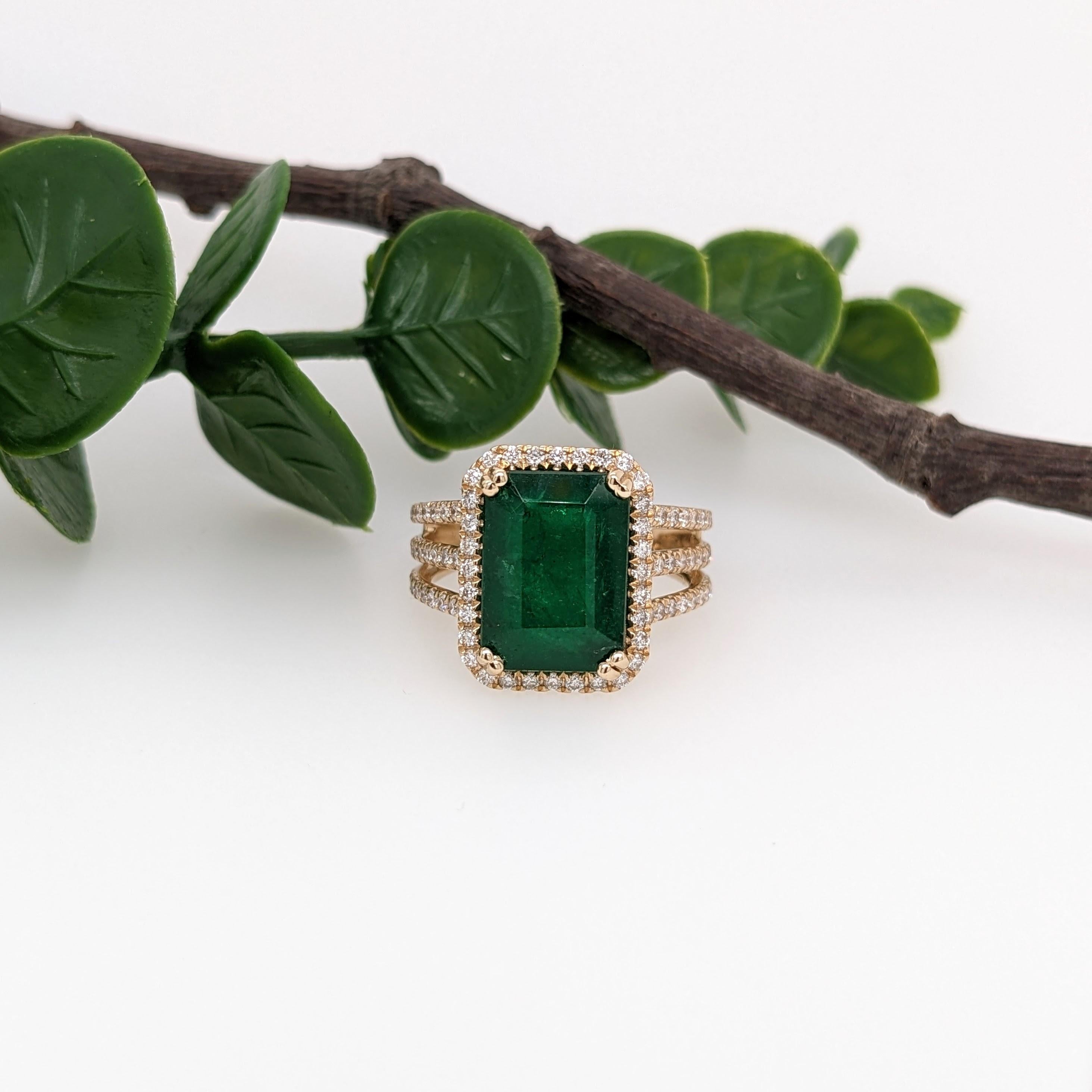 A gorgeous ring featuring a beautiful deep green emerald set in solid 14k yellow gold with all natural diamond accents. Enjoy a little extra sparkle with the diamond studded layered split shank! A gorgeous modern look for an elegant addition to any