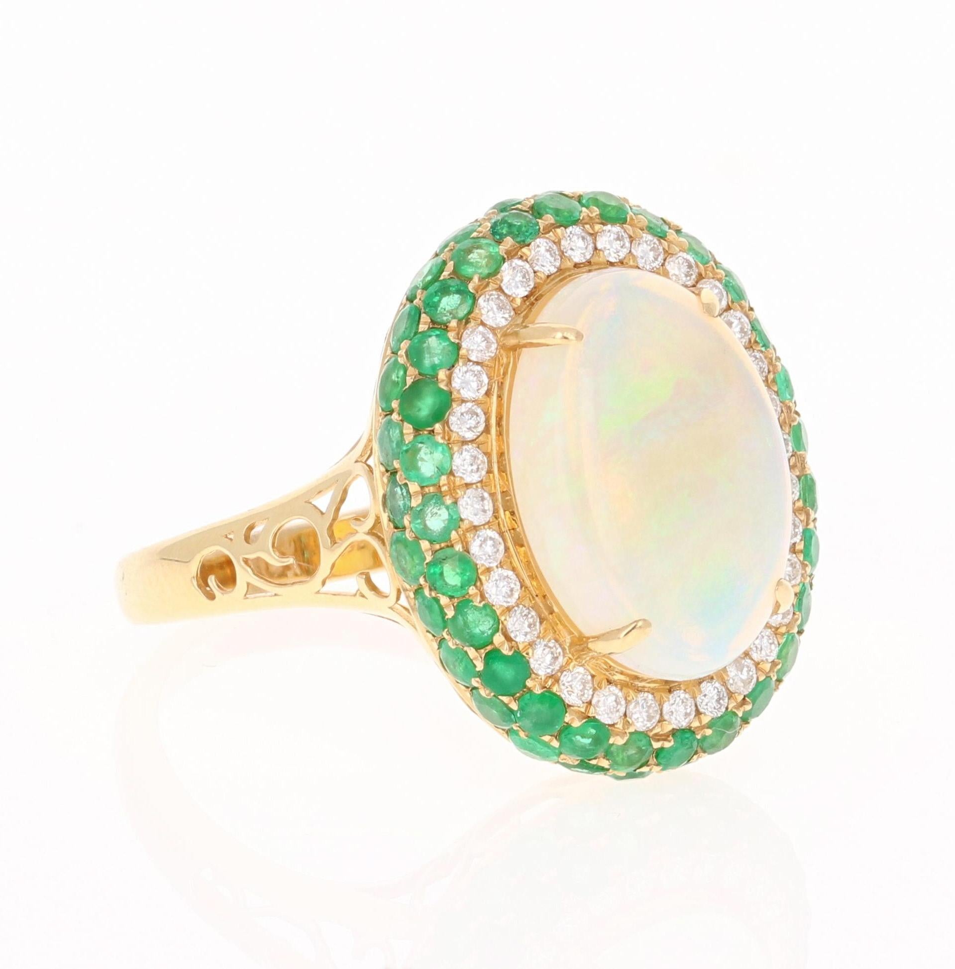 This stunning ring has an Opal that weighs 3.11 Carats with Emeralds that weigh 1.42 Carats and Diamonds that weigh 0.29 Carats. The total carat weight of the ring is 4.82 Carats. 

The ring is beautifully set in 18 Karat Yellow Gold and weighs