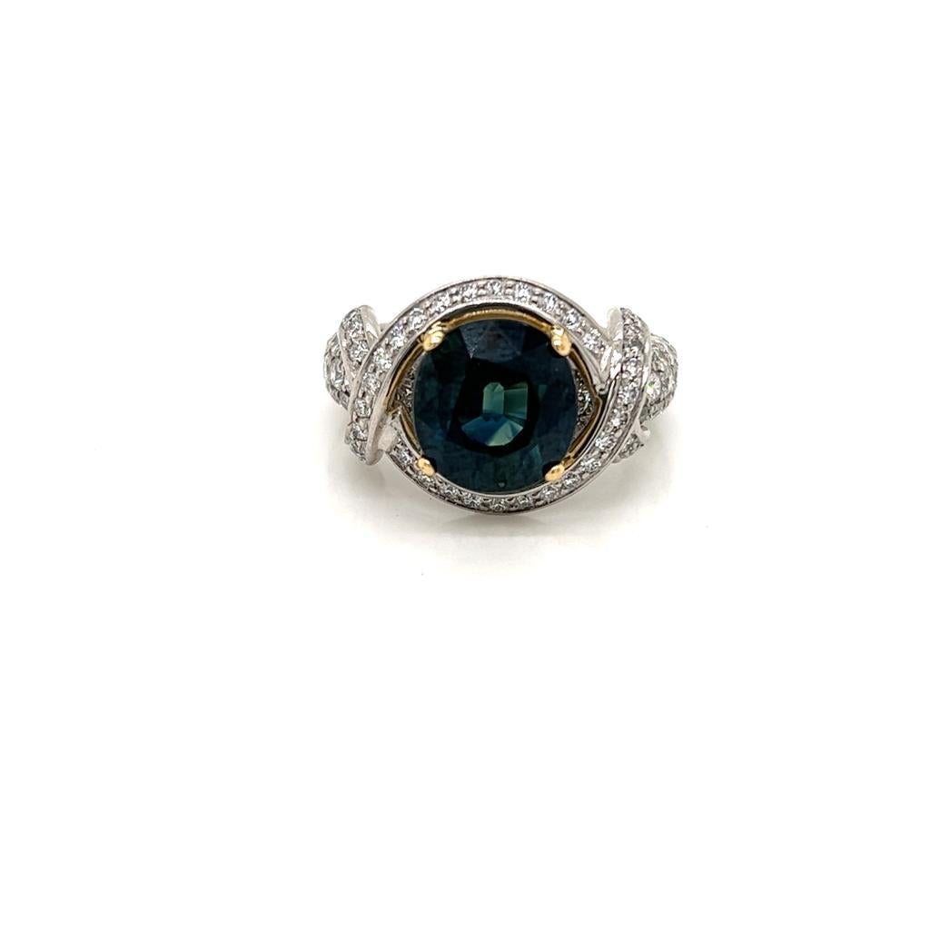 4.83 Carat Round Teal Sapphire and Diamond Ring in Platinum and 18 Karat Yellow Gold.

This gorgeous ring features a phenomenal 4.83 carat round Teal Sapphire held in an 18K Yellow Gold claw setting on an intricate Platinum band.

The intricate band