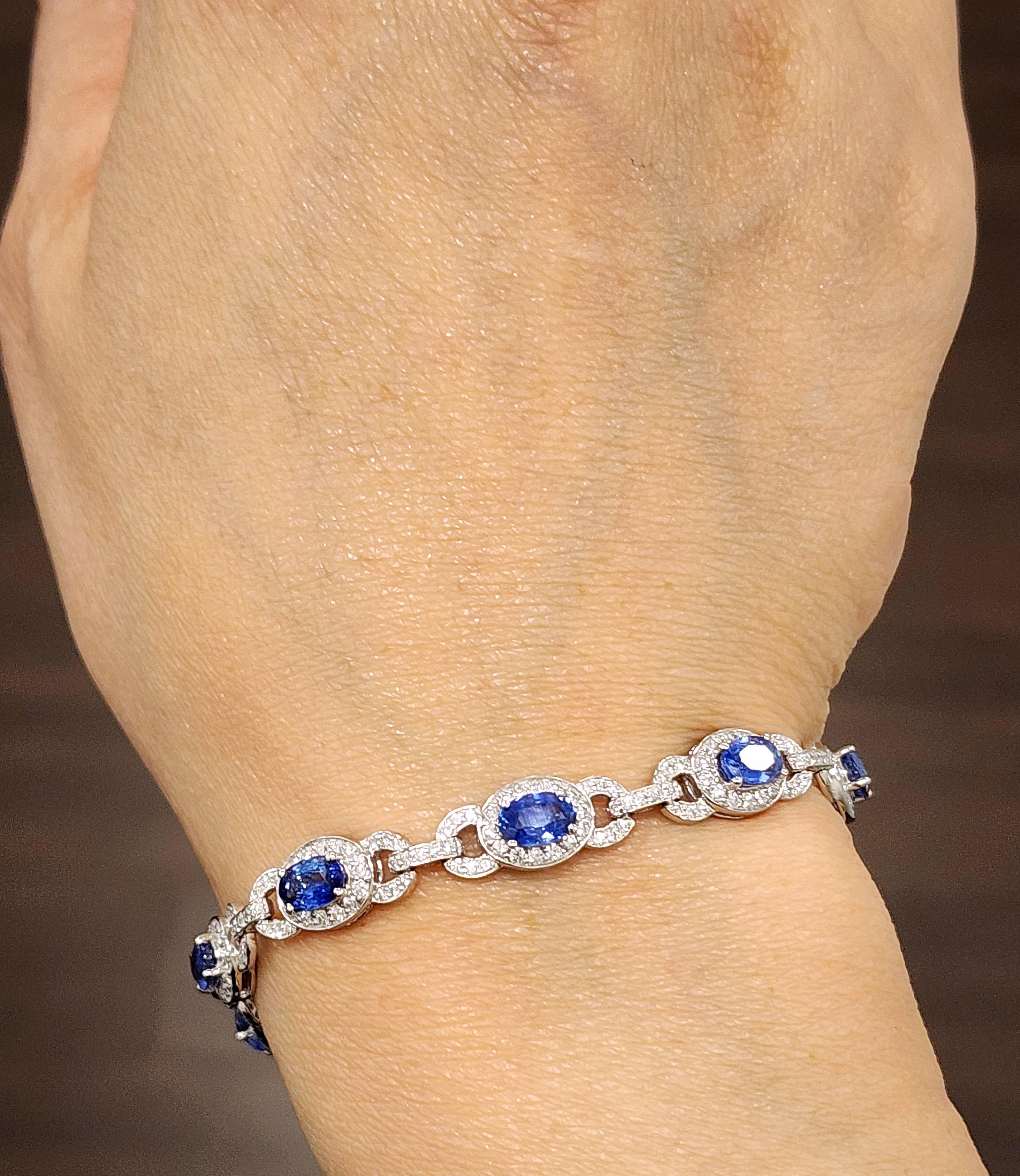 This elegant bracelet is a stunning creation. Featuring 2.40 carats of 10 oval-cut blue sapphires, each stone is vibrant and captivating. Complemented by 2.43 carats of 321 round-cut diamonds, the diamonds are of F/G color and VS1/VS2 clarity,